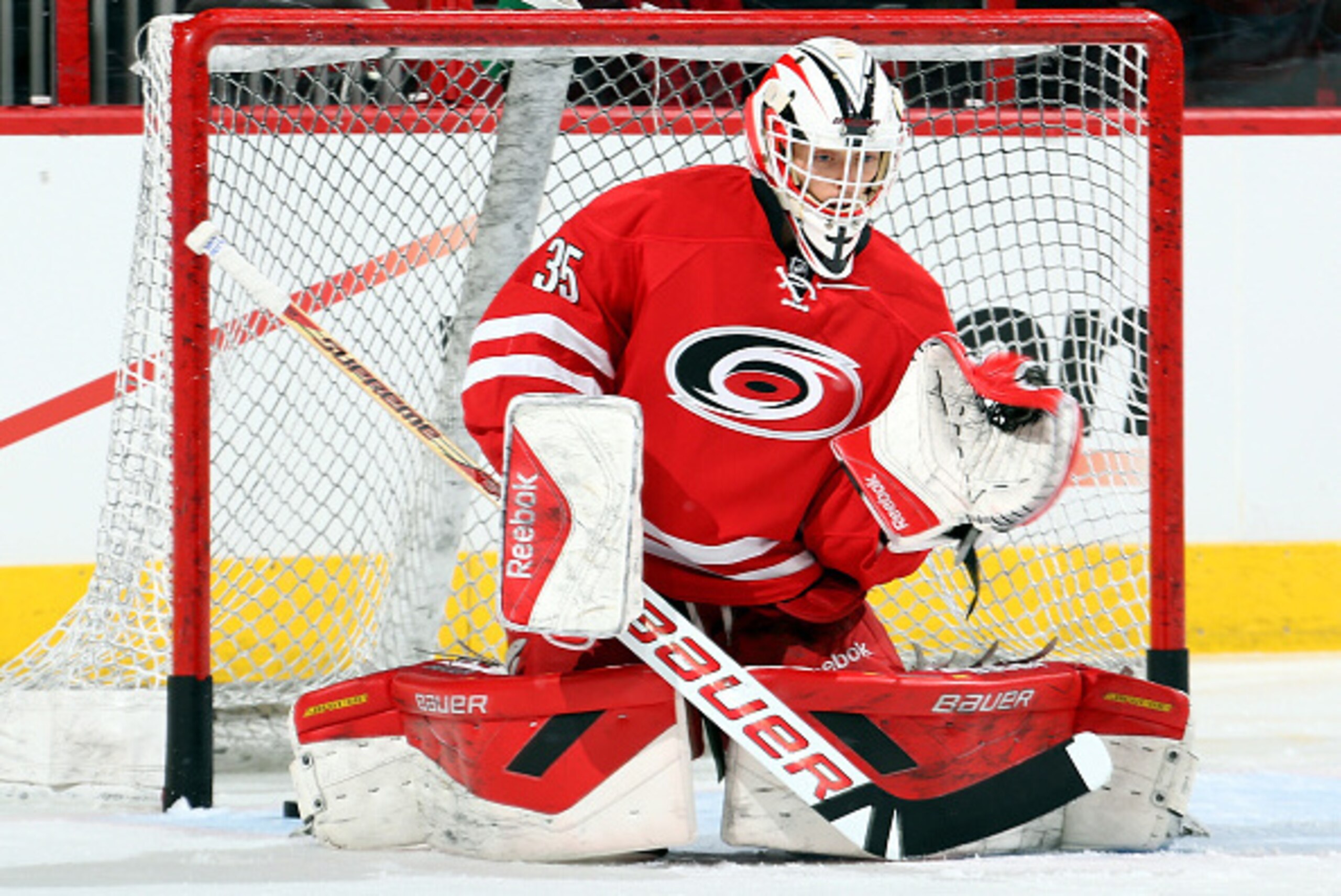 RALEIGH, NC - DECEMBER 04: Drew MacIntyre #35 of the Carolina Hurricanes snares a puck during warmups prior to an NHL game against the Washington Capitals at PNC Arena on December 4, 2014 in Raleigh, North Carolina. The Hurricanes recalled MacIntyre from 
