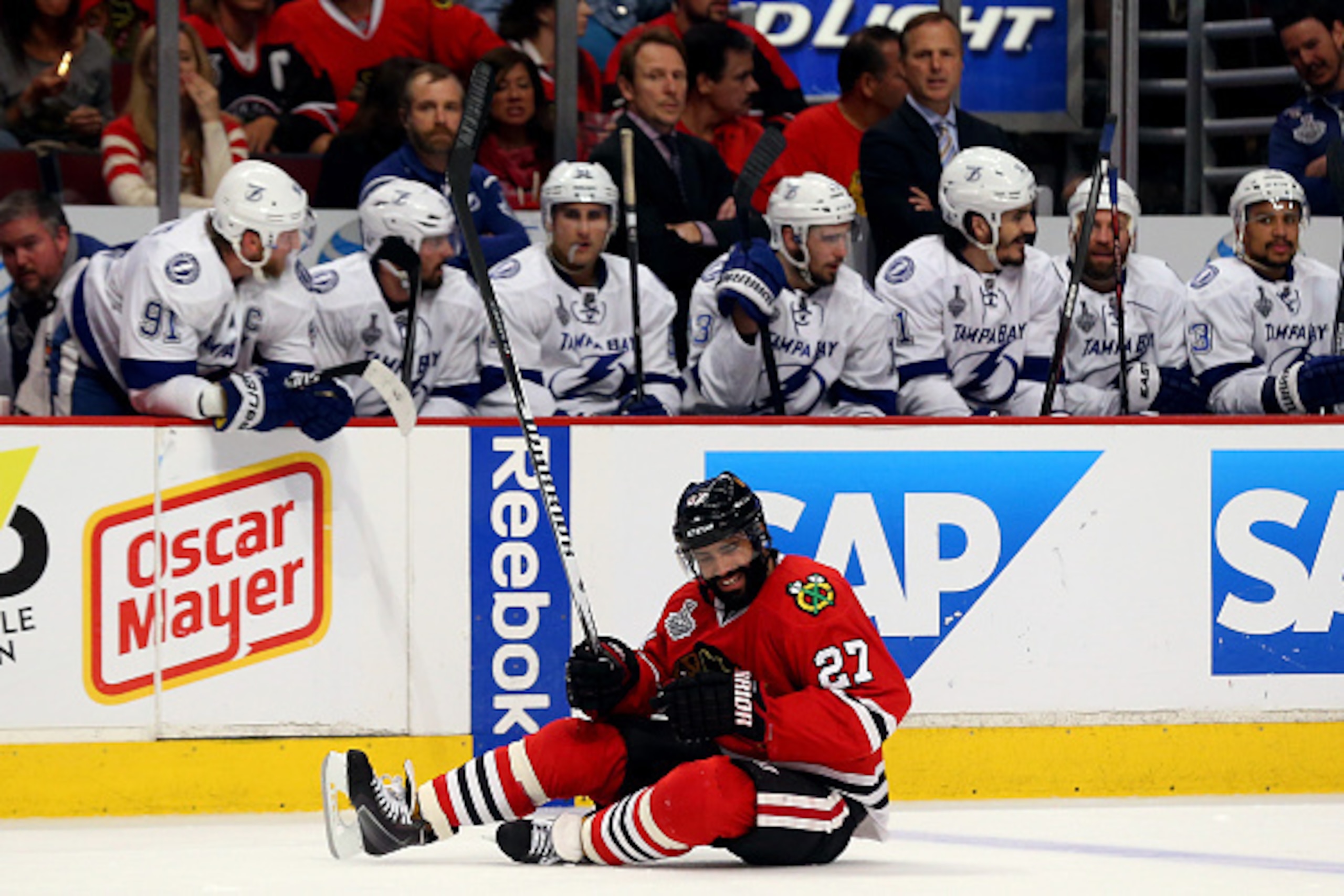CHICAGO, IL - JUNE 08: Johnny Oduya #27 of the Chicago Blackhawks reacts after a check against the Tampa Bay Lightning during Game Three of the 2015 NHL Stanley Cup Final at the United Center on June 8, 2015 in Chicago, Illinois.  (Photo by Bruce Bennett/