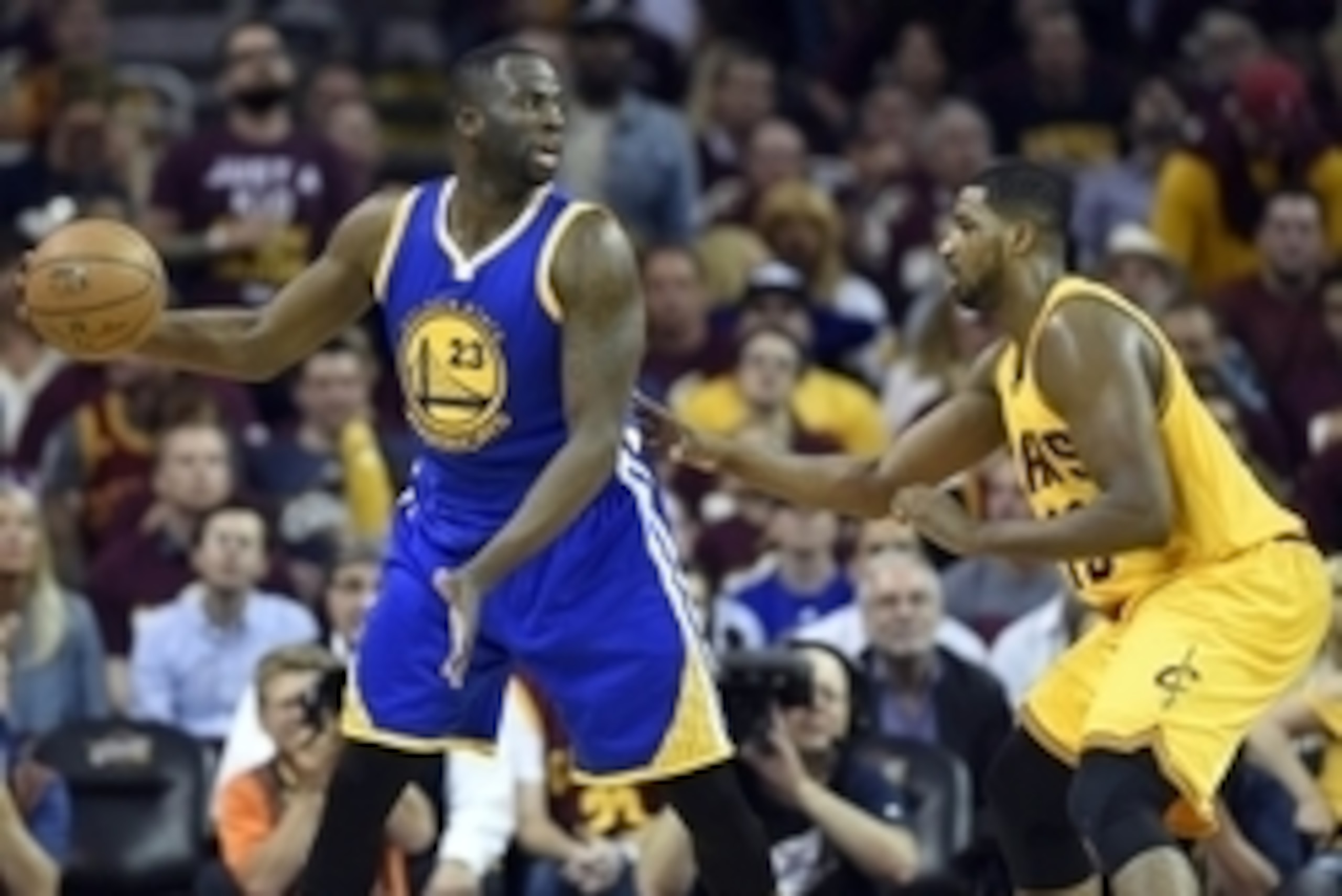 Jun 9, 2015; Cleveland, OH, USA; Golden State Warriors forward Draymond Green (23) handles the ball against Cleveland Cavaliers center Tristan Thompson (13) during the third quarter in game three of the NBA Finals at Quicken Loans Arena. Mandatory Credit: