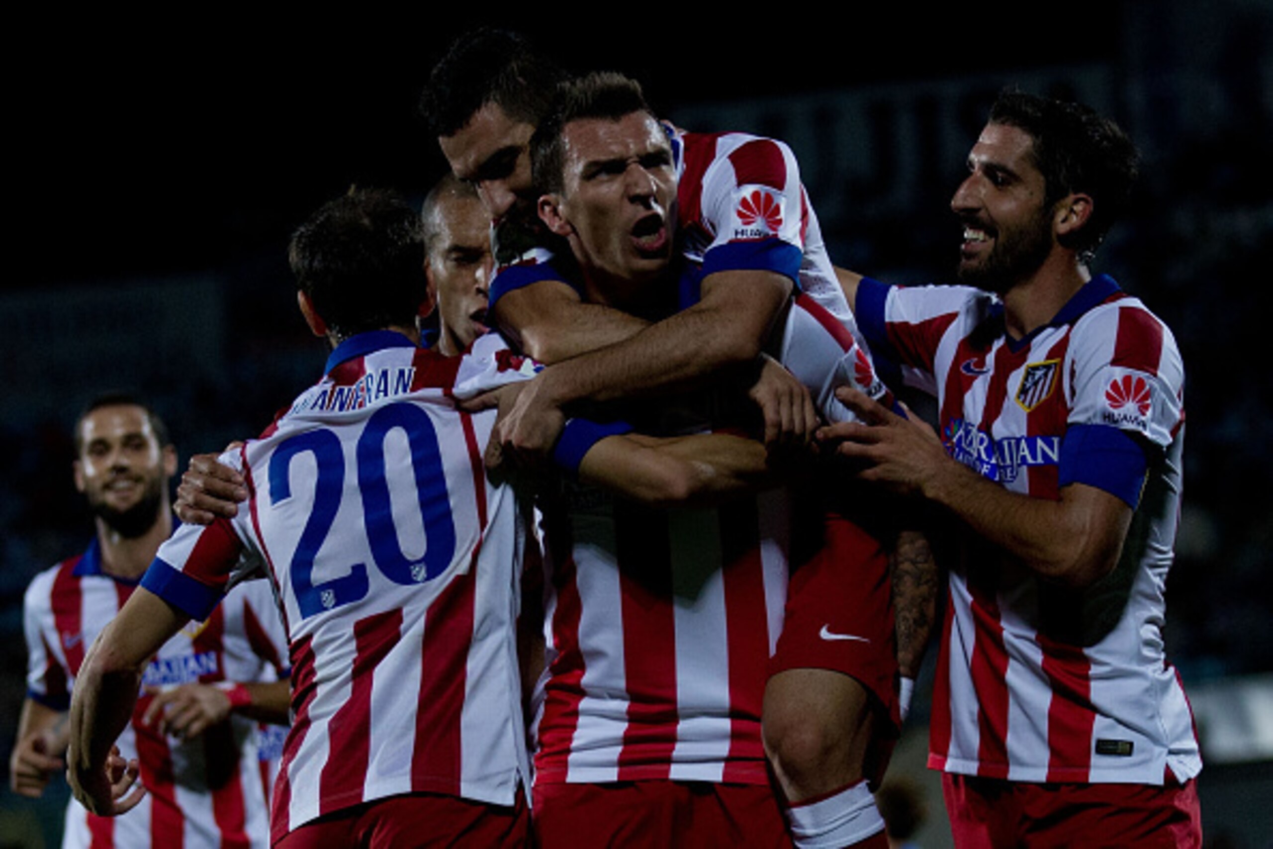 GETAFE, SPAIN - OCTOBER 26:  Mario Mandzukic of Atletico de Madrid celebrates scoring their opening goal with teammates during the La Liga match between Getafe CF and Club Atletico de Madrid at Coliseum Alfonso Perez on October 26, 2014 in Getafe, Spain. 