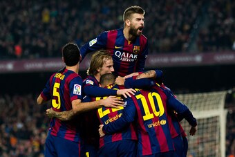 BARCELONA, SPAIN - JANUARY 11: Players of FC Barcelona as Gerard Pique (top) celebrate with their team-mate Neymar Santos Jr after he scored the opening goal during the La Liga match between FC Barcelona and Club Atletico de Madrid at Camp Nou on January 
