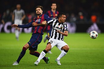 BERLIN, GERMANY - JUNE 06:  Carlos Tevez of Juventus evades Gerard Pique of Barcelona during the UEFA Champions League Final between Juventus and FC Barcelona at Olympiastadion on June 6, 2015 in Berlin, Germany.  (Photo by Laurence Griffiths/Getty Images