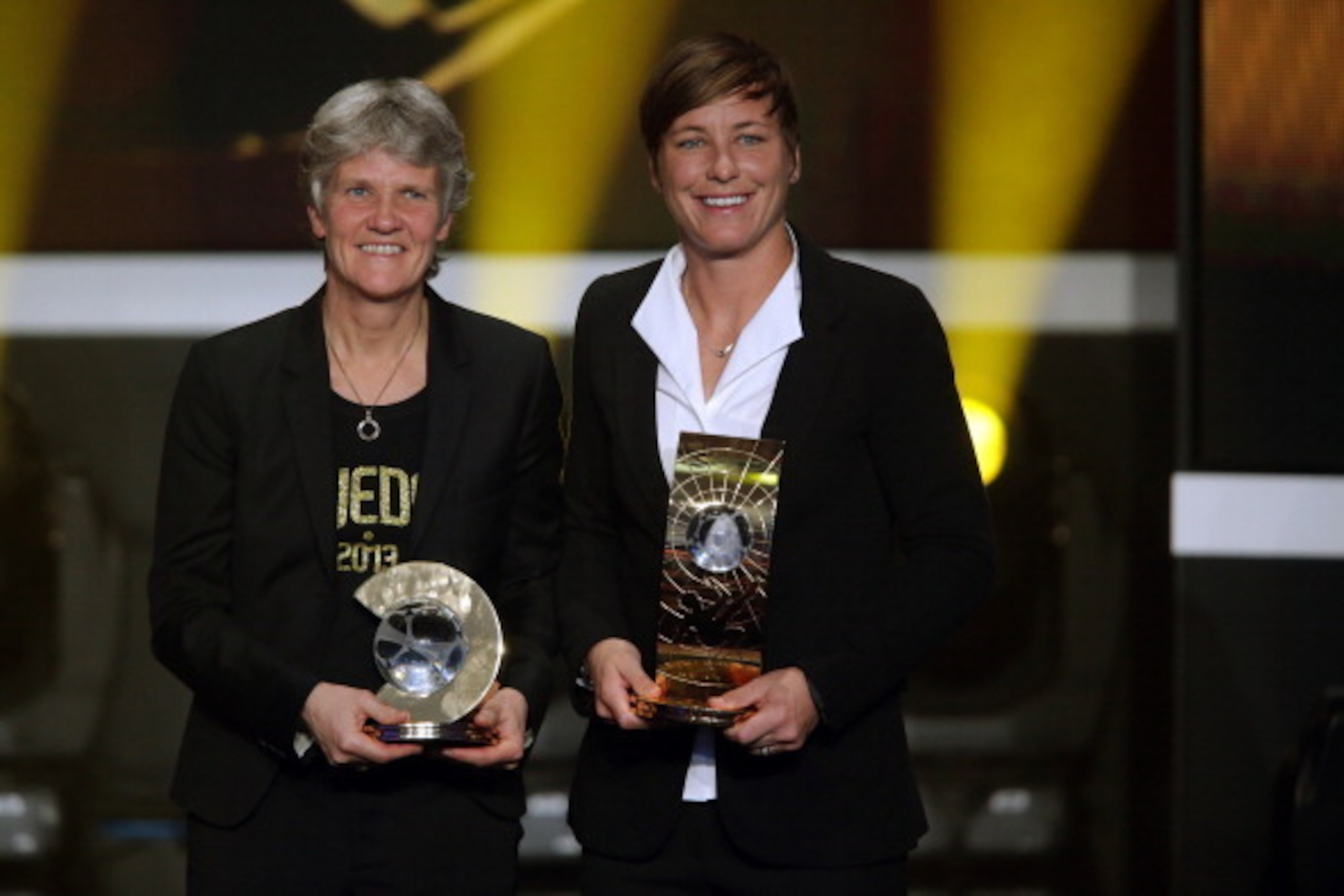 ZURICH, SWITZERLAND - JANUARY 07: Pia Sundhage, women's coach of United States receives the FIFA World Coach of Women's Football 2012 trophy and Abby Wambach of United States receives her FIFA womens player of the year trophy during the FIFA Ballon d'Or ZURICH, SWITZERLAND - JANUARY 07: Pia Sundhage, women's coach of United States receives the FIFA World Coach of Women's Football 2012 trophy and Abby Wambach of United States receives her FIFA womens player of the year trophy during the FIFA Ballon d'Or
