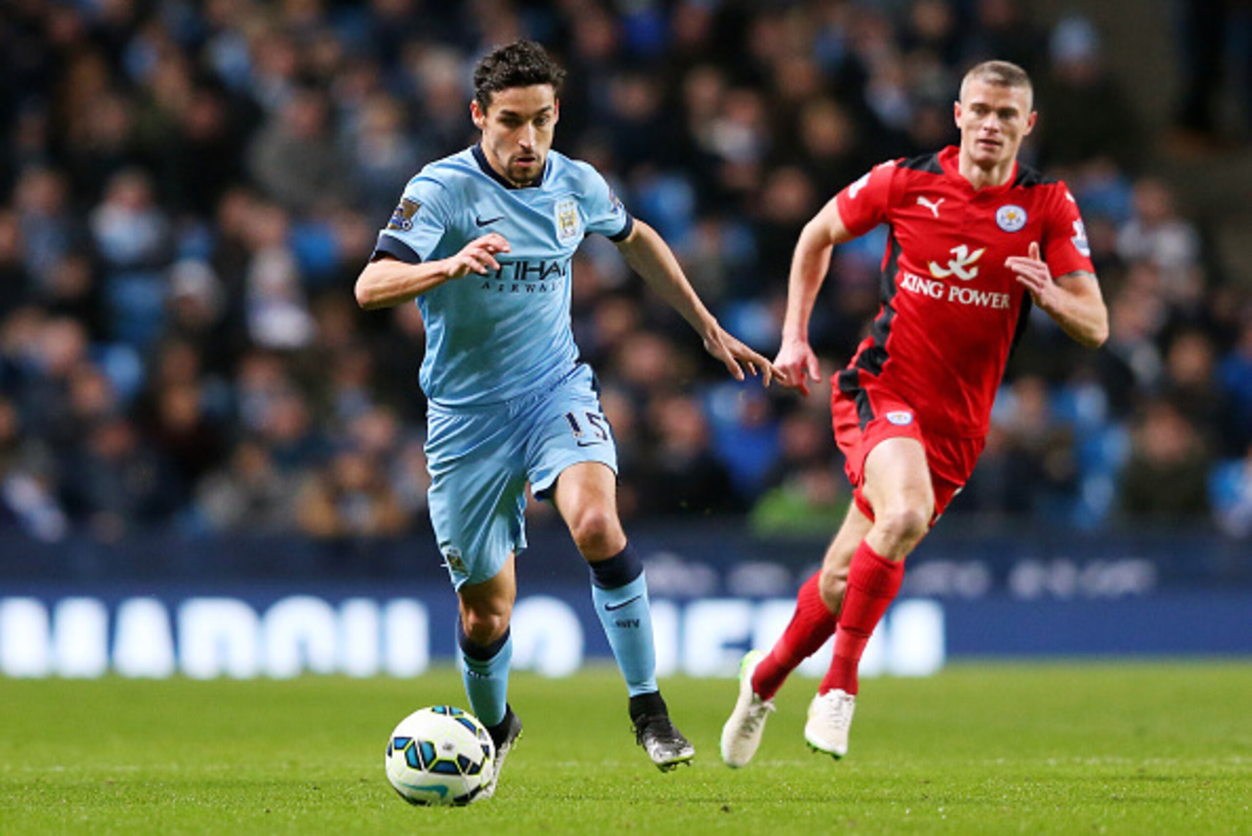 MANCHESTER, ENGLAND - MARCH 04:  Jesus Navas of Manchester City is ppursued by Paul Konchesky of Leicester City during the Barclays Premier League match between Manchester City and Leicester City at the Etihad Stadium on March 4, 2015 in Manchester, Engla