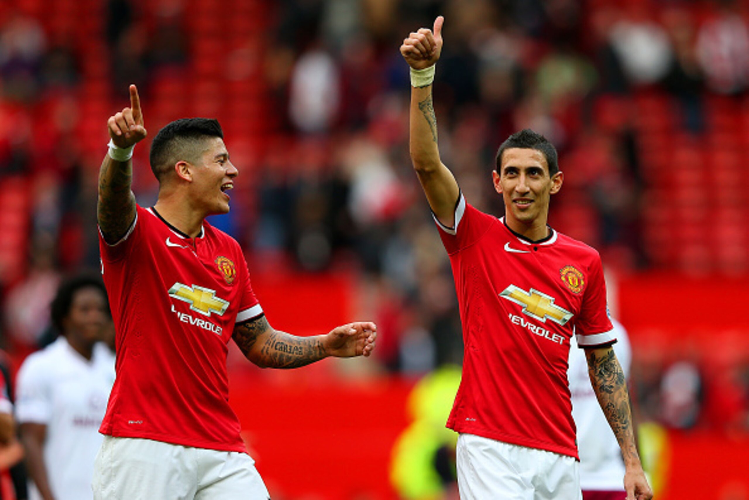 MANCHESTER, ENGLAND - APRIL 04:  Angel di Maria of Manchester United gives a thumbs up to the crowd next to team-mate Marcos Rojo after the Barclays Premier League match between Manchester United and Aston Villa at Old Trafford on April 4, 2015 in Manches