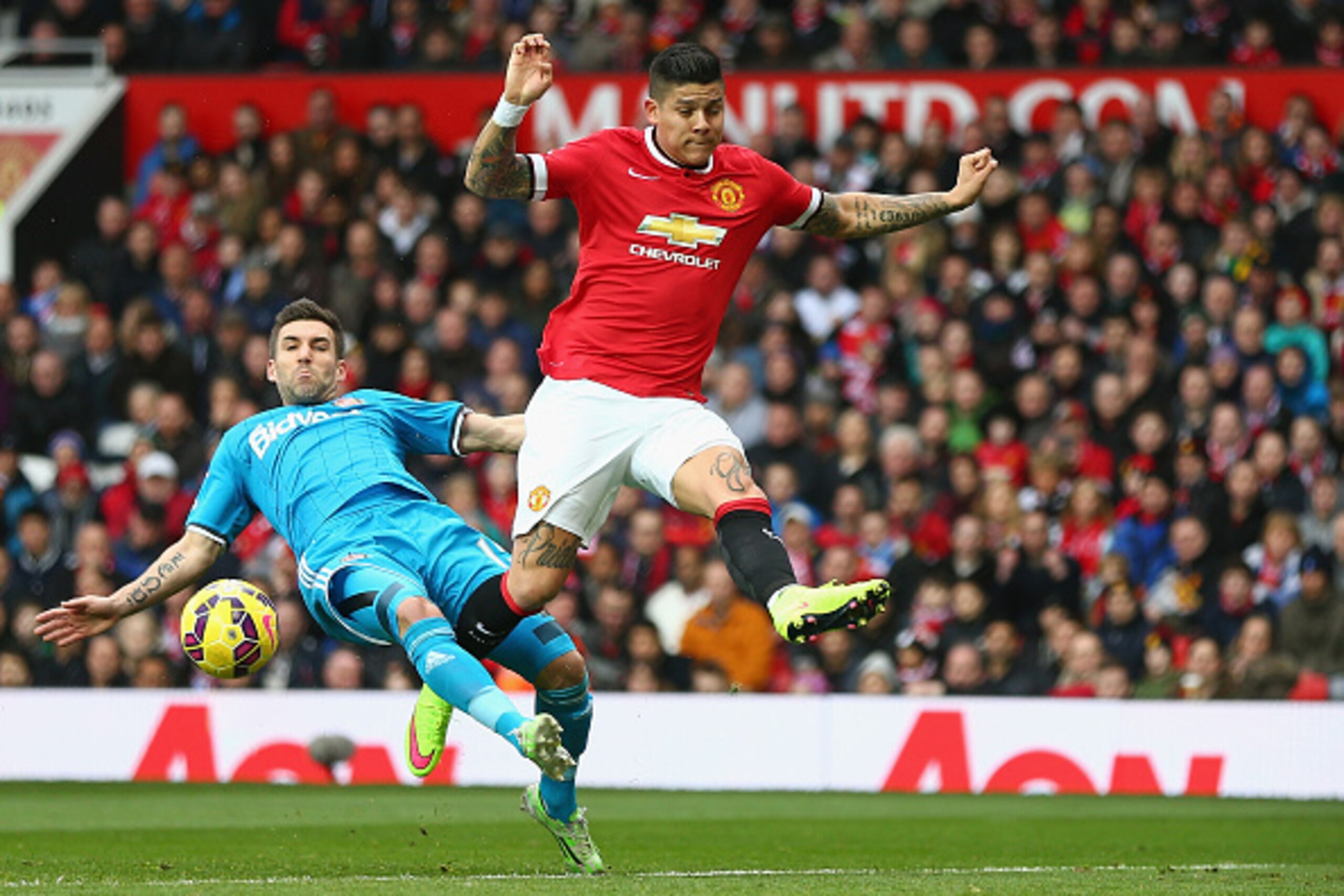 MANCHESTER, ENGLAND - FEBRUARY 28:  Marcos Rojo of Manchester United in action with Anthony Reveillere of Sunderland during the Barclays Premier League match between Manchester United and Sunderland at Old Trafford on February 28, 2015 in Manchester, Engl