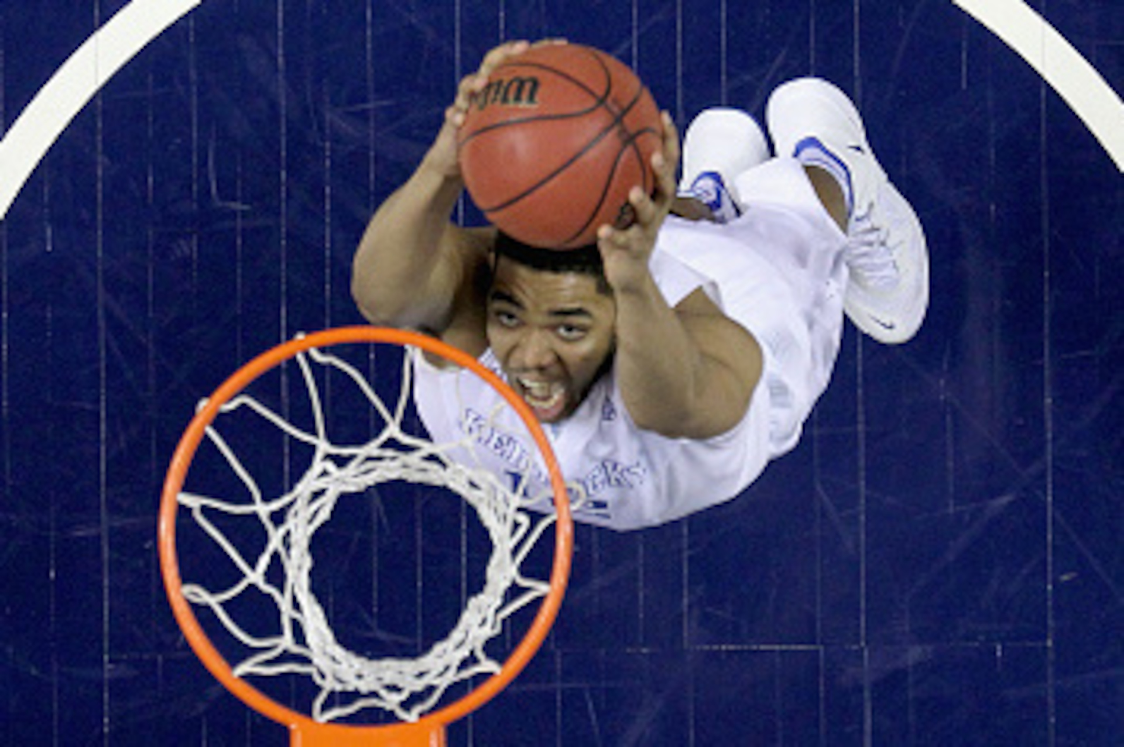 NASHVILLE, TN - MARCH 15:  Karl-Anthony Towns #12 of the Kentucky Wildcats dunks the ball against the Arkansas Razorbacks in the championship game of the SEC Basketball Tournament at Bridgestone Arena on March 15, 2015 in Nashville, Tennessee.  (Photo by 