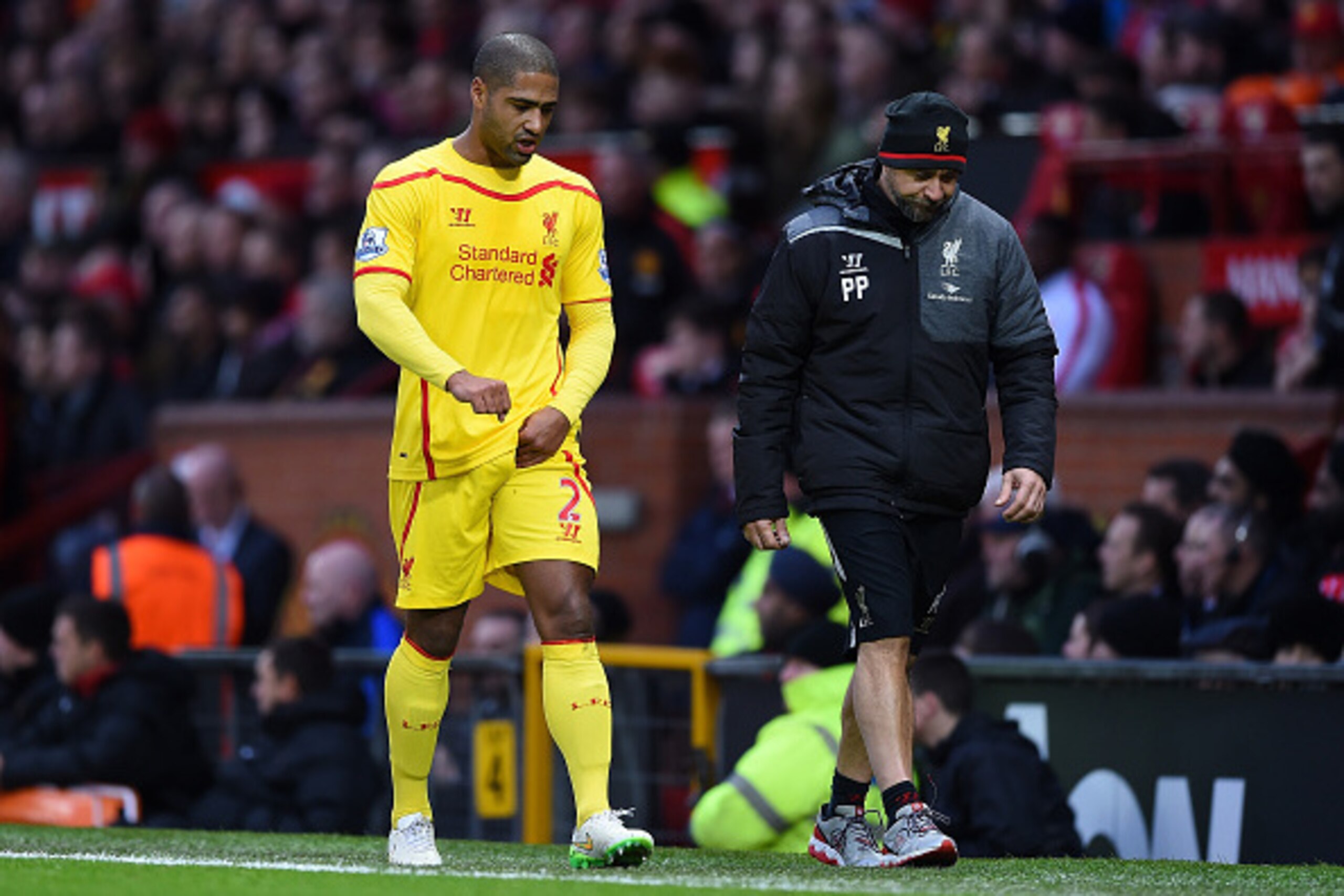 MANCHESTER, ENGLAND - DECEMBER 14:  Glen Johnson of Liverpool goes off after sustaining an injury during the Barclays Premier League match between Manchester United and Liverpool at Old Trafford on December 14, 2014 in Manchester, England.  (Photo by Shau