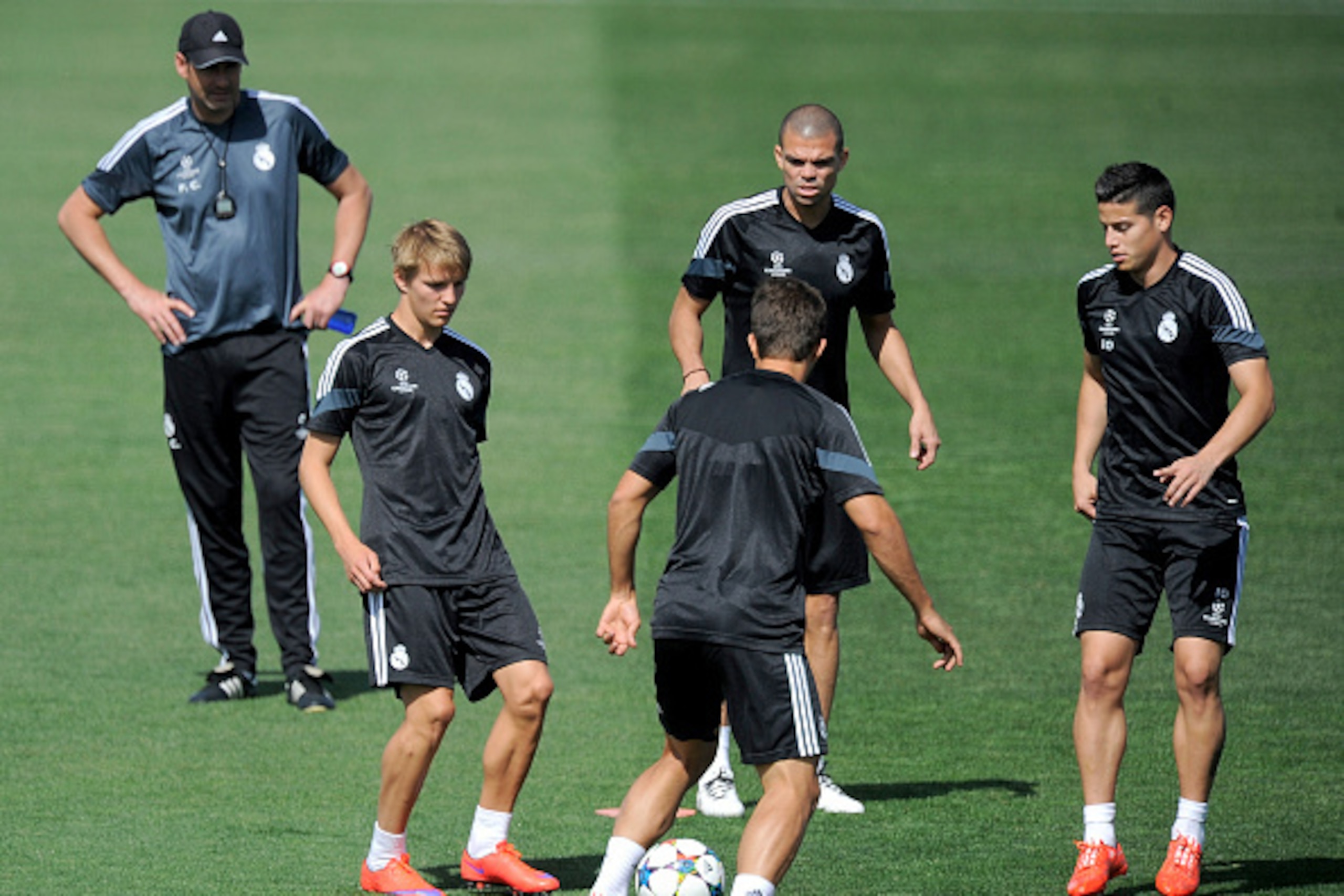 MADRID, SPAIN - MAY 12:  Martin Odegaard of Real Madrid trains with teammates Pepe and James Rodriguez during the Real Madrid CF training session ahead of the UEFA Champions League Semi Final, Second Leg against Juventus at Valdebebas training ground on M