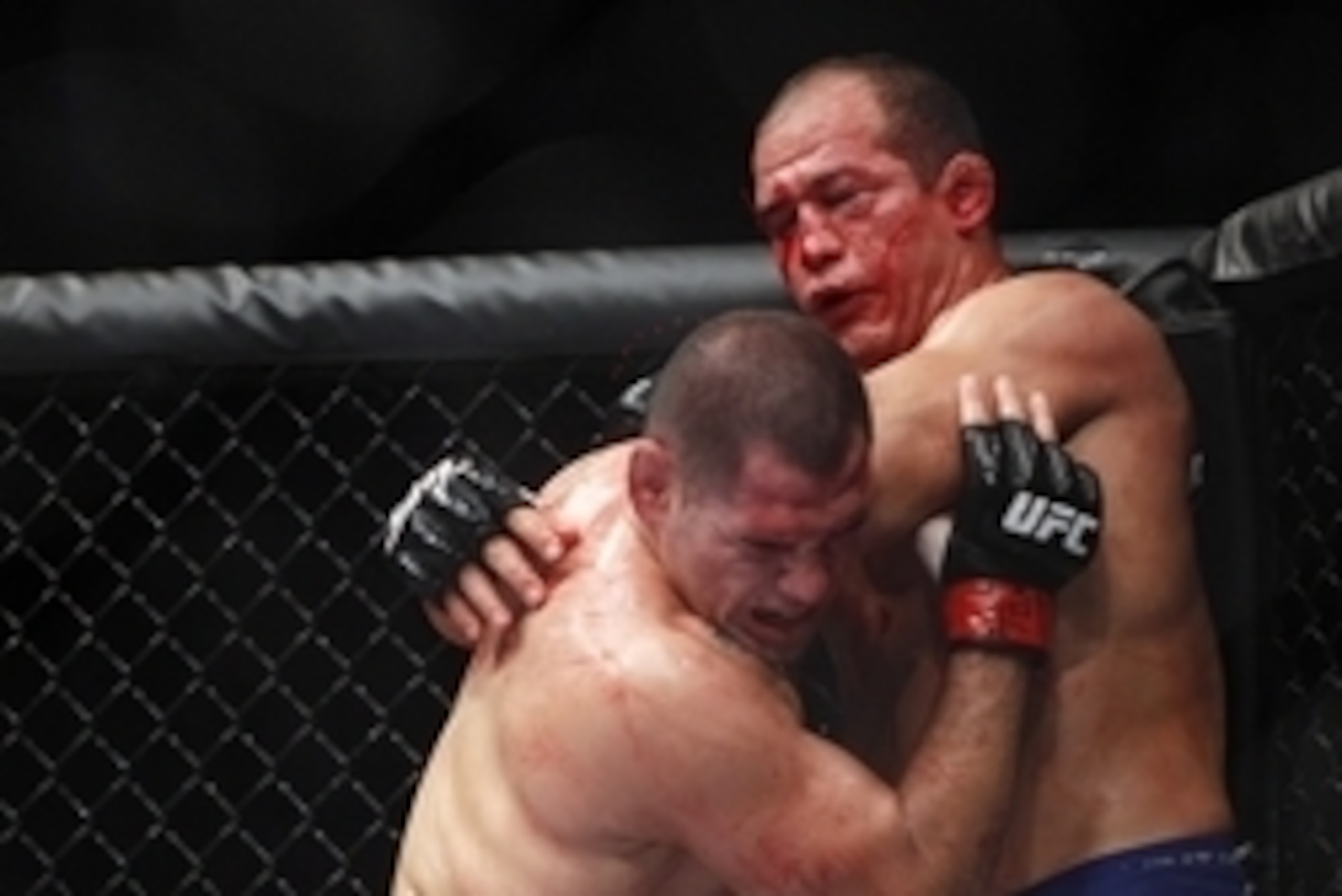 Oct 19, 2013; Houston, TX, USA; Cain Velasquez (red gloves) fights against Junior Dos Santos (blue gloves) in the world heavyweight championship bout during UFC 166 at Toyota Center. Mandatory Credit: Andrew Richardson-USA TODAY Sports