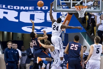 Jan 8, 2015; Provo, UT, USA; Pepperdine Waves guard Shawn Olden (21) tries to shoot the ball over Brigham Young Cougars guard Frank Bartley IV (24) during the second half at Marriott Center. Pepperdine Waves won the game 67-61. Mandatory Credit: Chris Nic