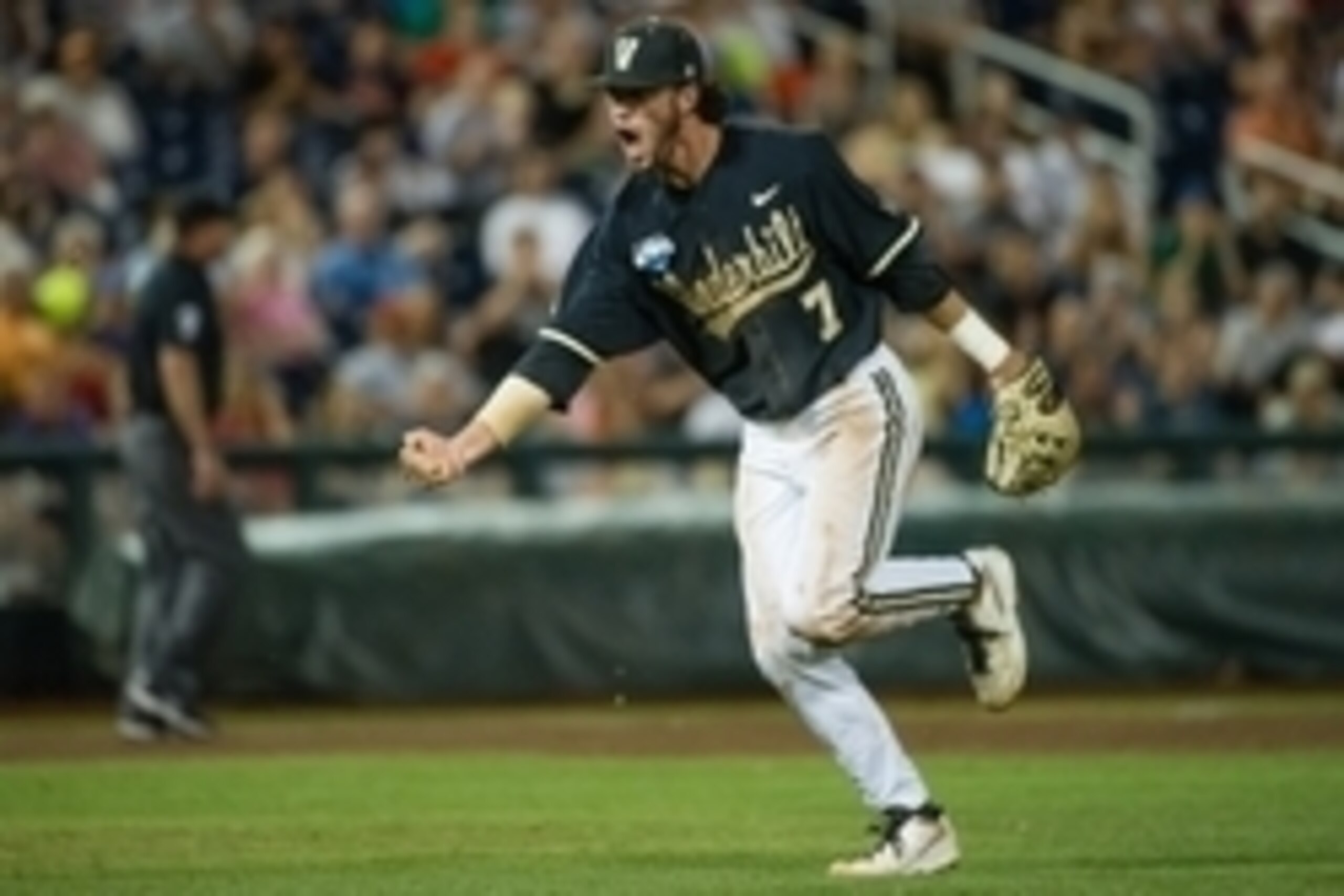 Jun 25, 2014; Omaha, NE, USA; Vanderbilt Commodores infielder Dansby Swanson (7) celebrates an inning ending play in the eighth inning against the Virginia Cavaliers during game three of the College World Series Finals at TD Ameritrade Park Omaha. Vanderb
