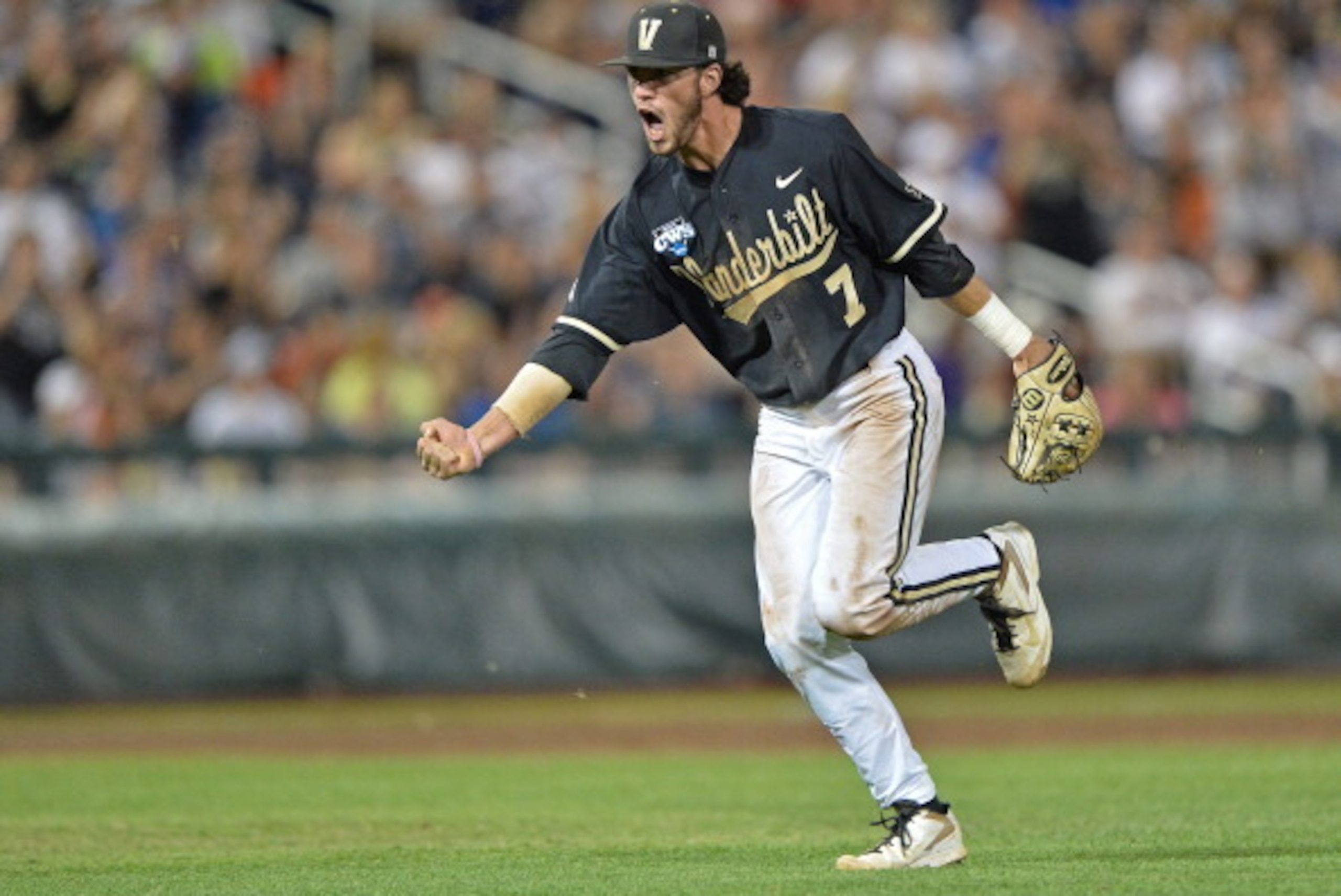 Omaha, NE - JUNE 25:  Second basemen Dansby Swanson #7 of the Vanderbilt Commodores celebrates after recording the final out of the eighth inning against the Virginia Cavaliers during game three of the College World Series Championship Series on June 25, 