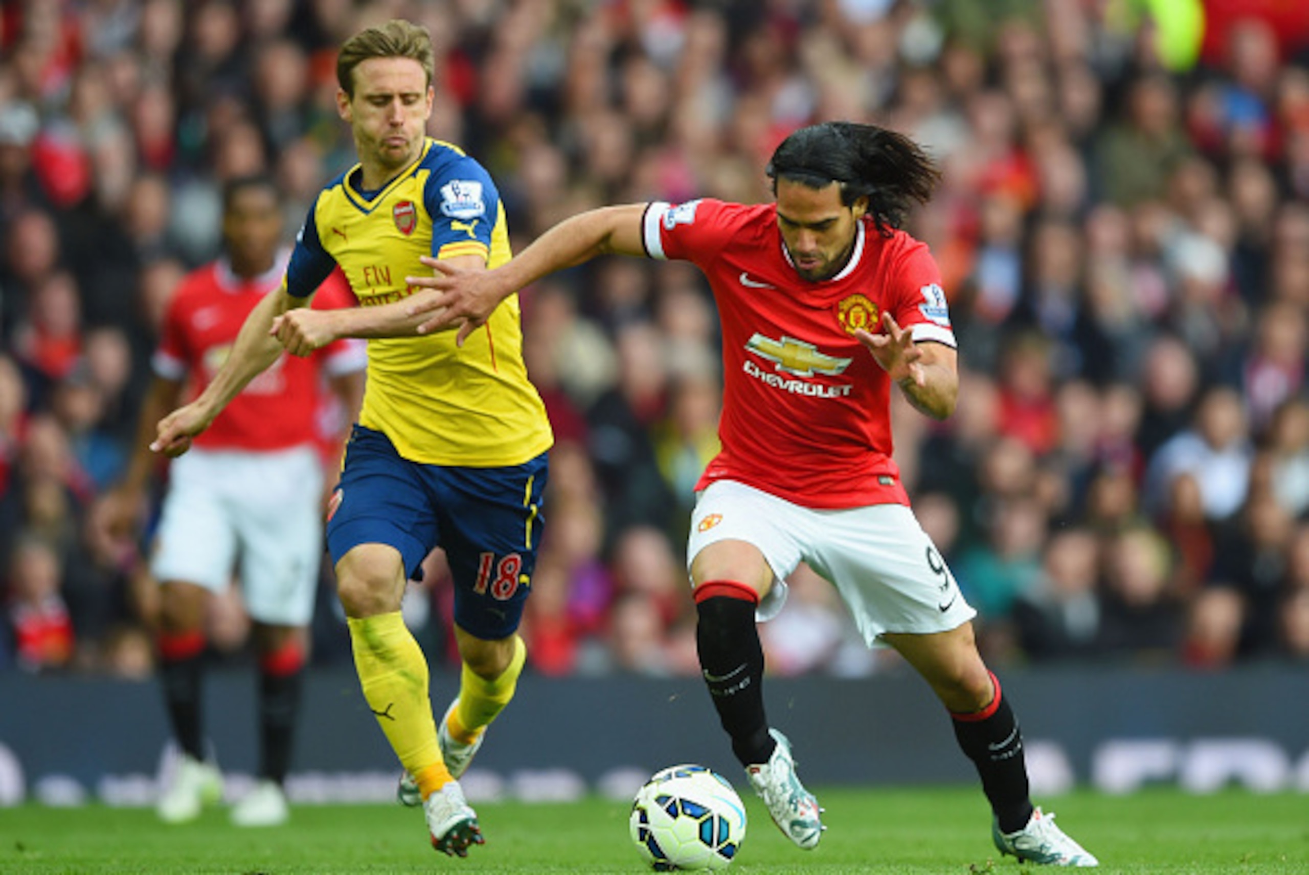 MANCHESTER, ENGLAND - MAY 17:  Radamel Falcao Garcia of Manchester United takes on Nacho Monreal of Arsenal during the Barclays Premier League match between Manchester United and Arsenal at Old Trafford on May 17, 2015 in Manchester, England.  (Photo by S