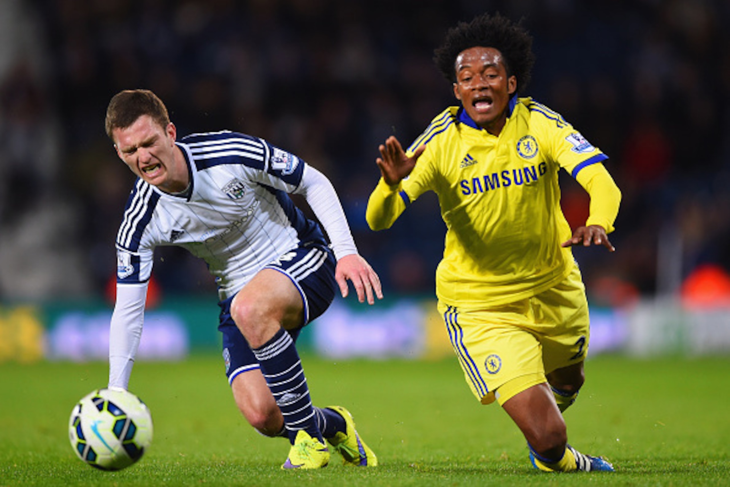 WEST BROMWICH, ENGLAND - MAY 18:  Craig Gardner of West Bromwich Albion and Juan Cuadrado of Chelsea stumble as they battle for the ball during the Barclays Premier League match between West Bromwich Albion and Chelsea at The Hawthorns on May 18, 2015 in 