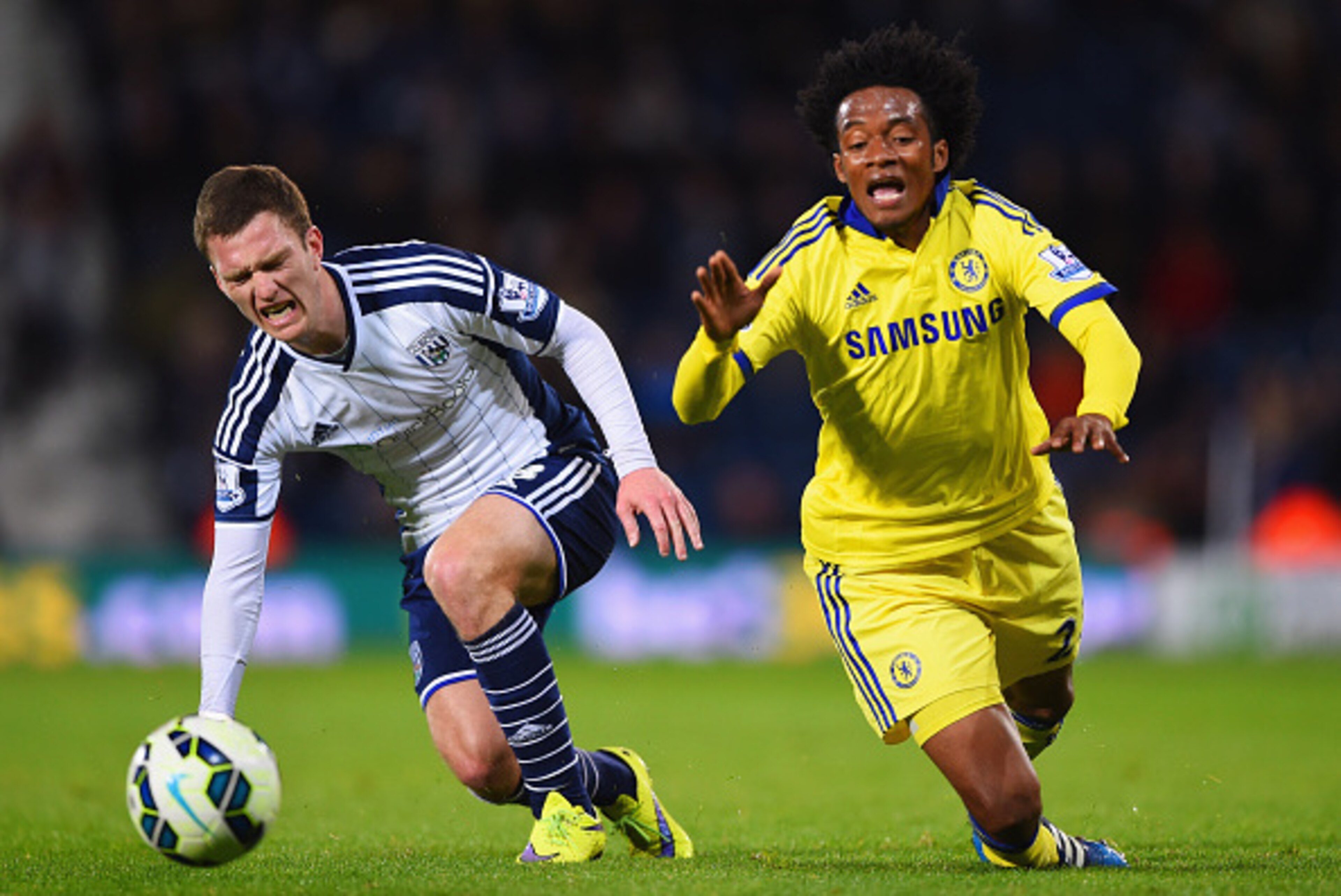 WEST BROMWICH, ENGLAND - MAY 18:  Craig Gardner of West Bromwich Albion and Juan Cuadrado of Chelsea stumble as they battle for the ball during the Barclays Premier League match between West Bromwich Albion and Chelsea at The Hawthorns on May 18, 2015 in 
