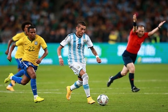 BEIJING, CHINA - OCTOBER 11:  Pereyra of Argentina (Center) competes the ball with Pastore of Brazil (Left) during Super Clasico de las Americas between Argentina and Brazil at Beijing National Stadium on October 11, 2014 in Beijing, China.  (Photo by Fen