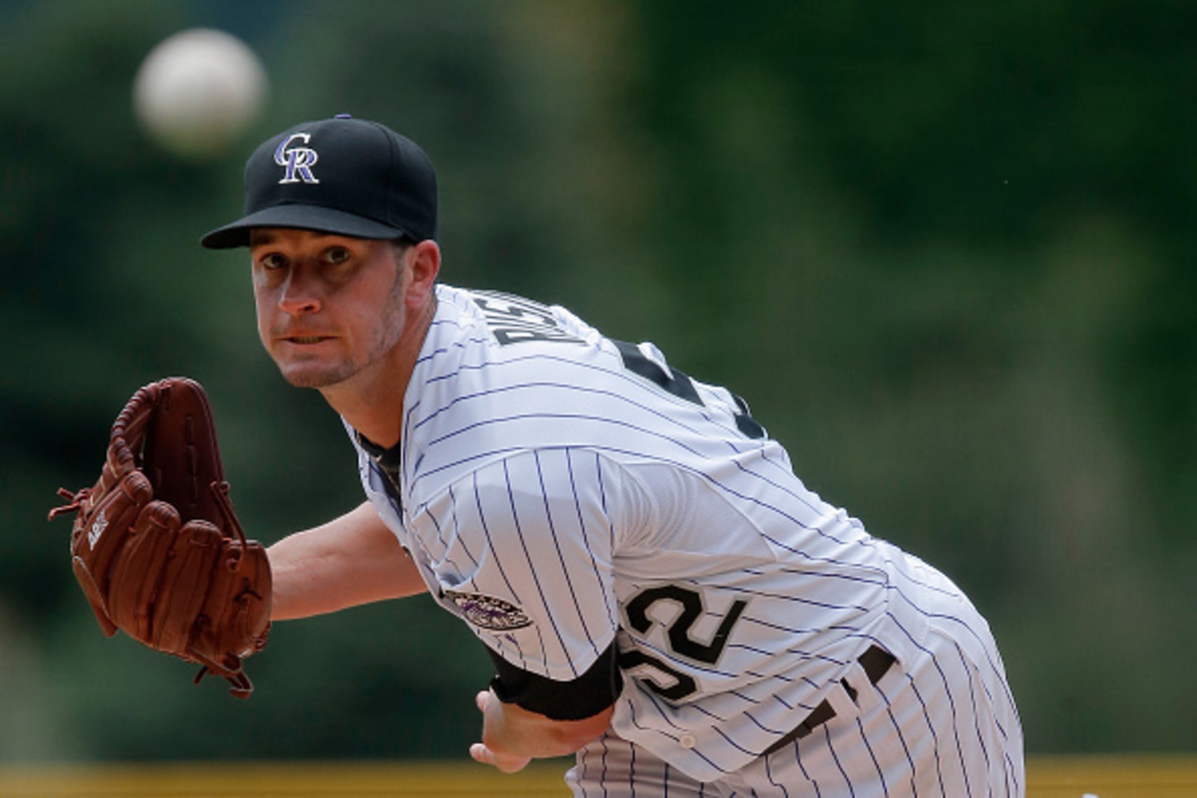 DENVER, CO - JUNE 06:  Starting pitcher Chris Rusin #52 of the Colorado Rockies delivers against the Miami Marlins at Coors Field on June 6, 2015 in Denver, Colorado.  (Photo by Doug Pensinger/Getty Images)