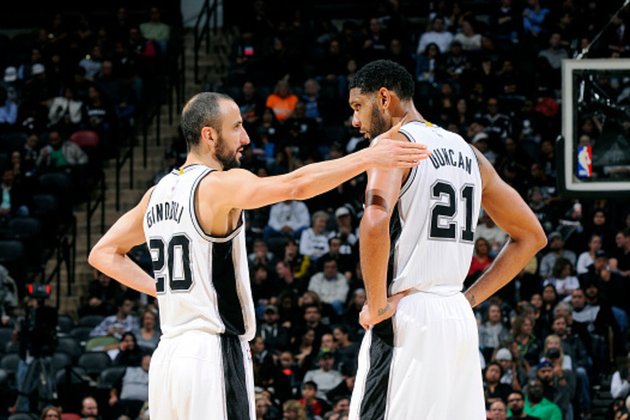 SAN ANTONIO, TX - NOVEMBER 5: Manu Ginobili #20 and Tim Duncan #21 of the San Antonio Spurs speak during a game against the Atlanta Hawks at the AT&T Center on November 5, 2014 in San Antonio, Texas. NOTE TO USER: User expressly acknowledges and agrees th