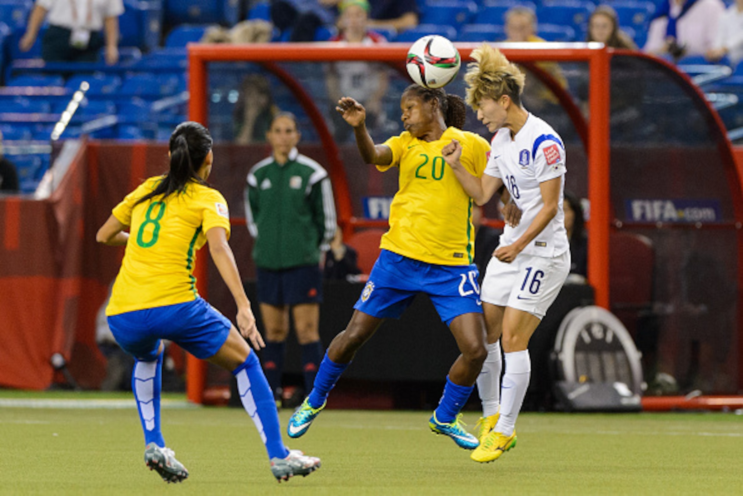 MONTREAL, QC - JUNE 09:  Formiga #20 of Brazil and Kang Yumi #16 of Korea Republic battle for the ball during the 2015 FIFA Women's World Cup Group E match at Olympic Stadium on June 9, 2015 in Montreal, Quebec, Canada. (Photo by Minas Panagiotakis/Getty 