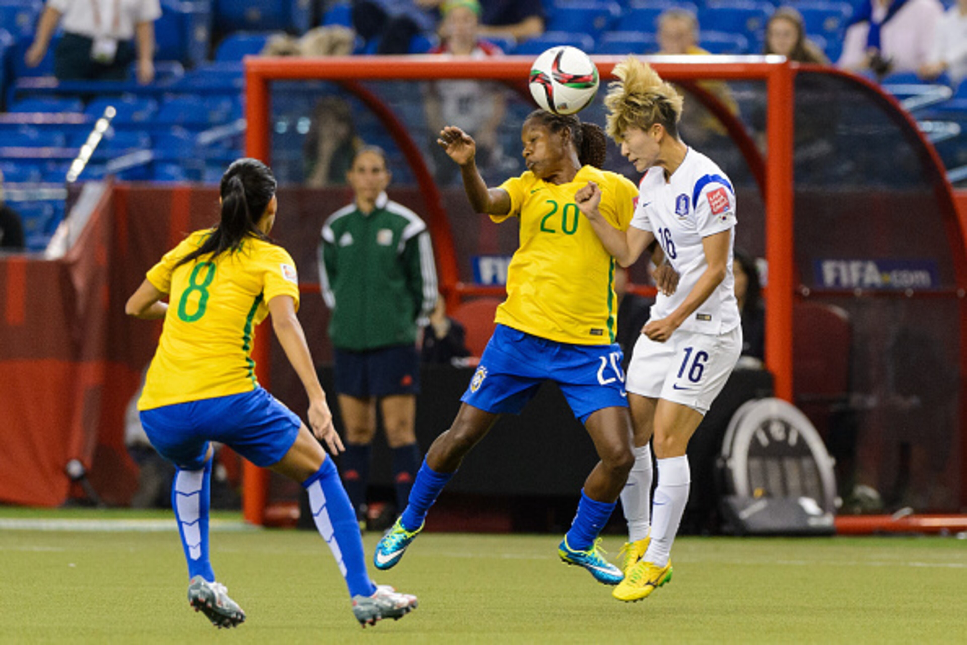 MONTREAL, QC - JUNE 09:  Formiga #20 of Brazil and Kang Yumi #16 of Korea Republic battle for the ball during the 2015 FIFA Women's World Cup Group E match at Olympic Stadium on June 9, 2015 in Montreal, Quebec, Canada. (Photo by Minas Panagiotakis/Getty 