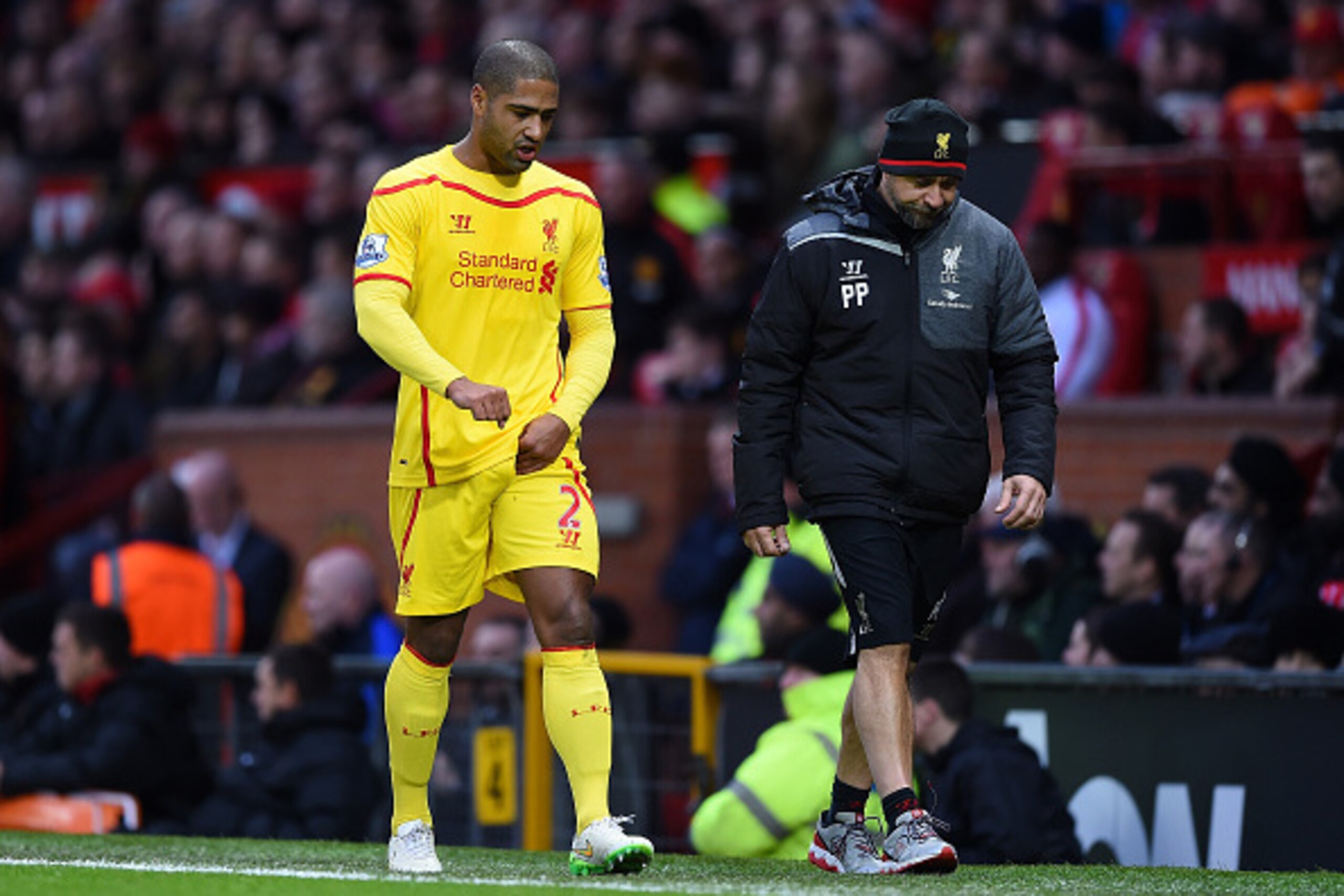 MANCHESTER, ENGLAND - DECEMBER 14:  Glen Johnson of Liverpool goes off after sustaining an injury during the Barclays Premier League match between Manchester United and Liverpool at Old Trafford on December 14, 2014 in Manchester, England.  (Photo by Shau