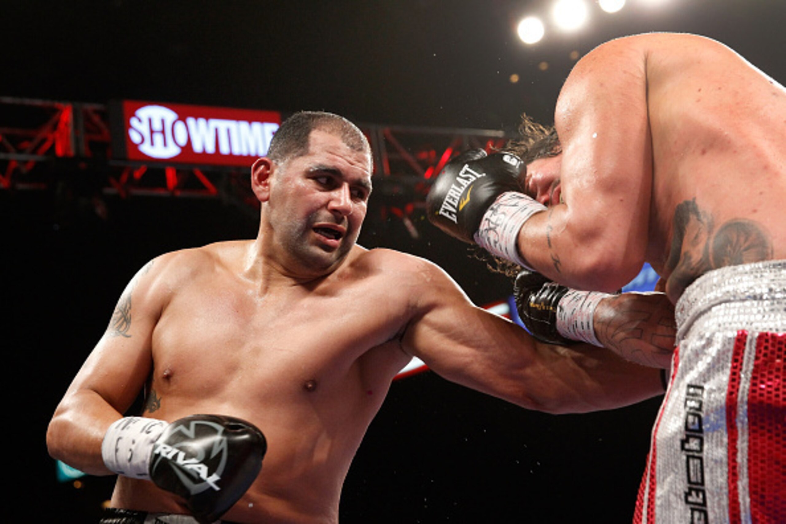 LAS VEGAS, NV - JANUARY 17:  Eric Molina lands a punch on Raphael Zumbano during a heavyweight fight at the MGM Grand Garden Arena on January 17, 2015 in Las Vegas, Nevada. Molina won the fight with an eighth-round TKO.  (Photo by Steve Marcus/Getty Image