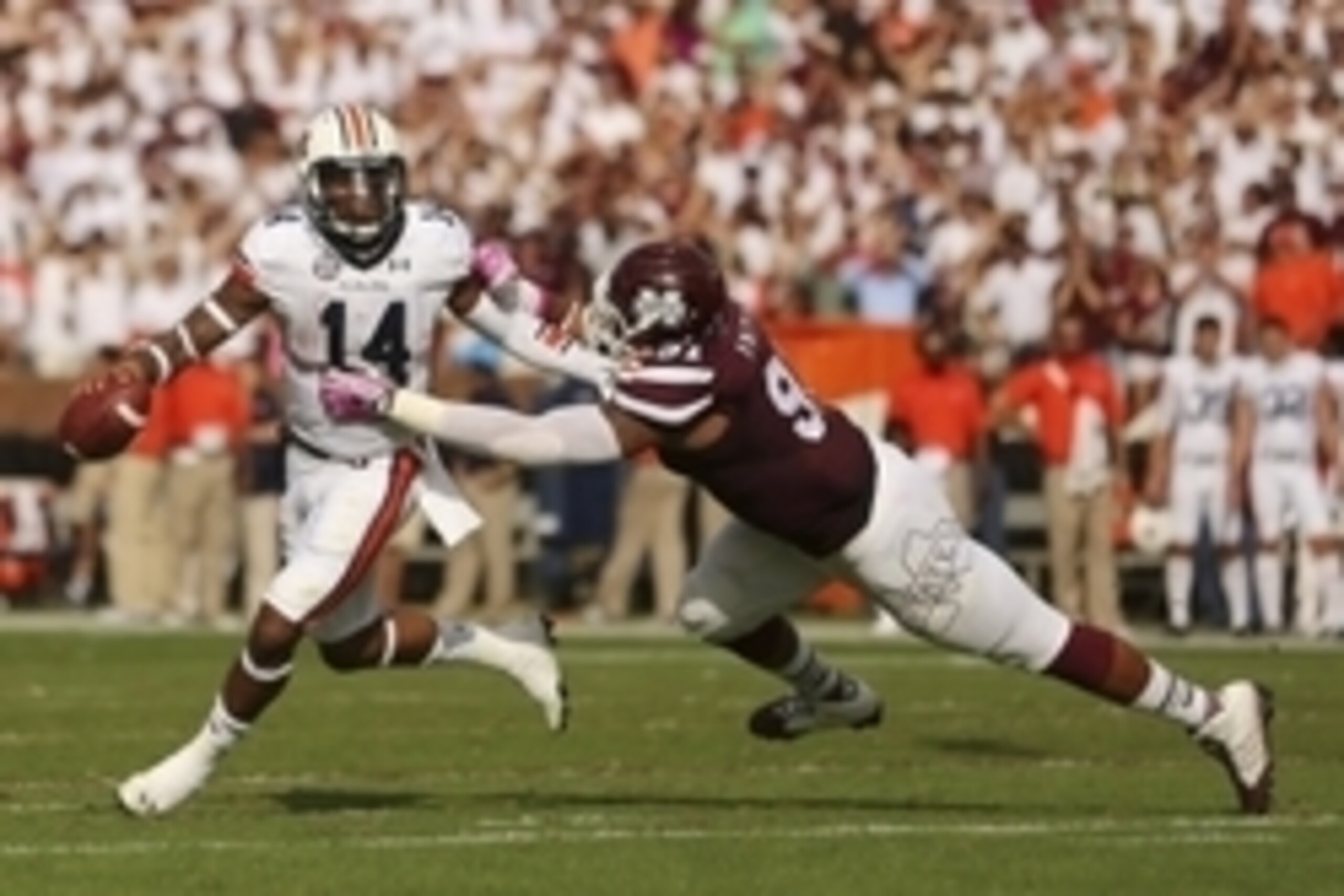 Oct 11, 2014; Starkville, MS, USA; Auburn Tigers quarterback Nick Marshall (14) steps out of the pocket and is chased by Mississippi State Bulldogs defensive lineman Preston Smith (91) during the game at Davis Wade Stadium. Mandatory Credit: Spruce Derden Oct 11, 2014; Starkville, MS, USA; Auburn Tigers quarterback Nick Marshall (14) steps out of the pocket and is chased by Mississippi State Bulldogs defensive lineman Preston Smith (91) during the game at Davis Wade Stadium. Mandatory Credit: Spruce Derden