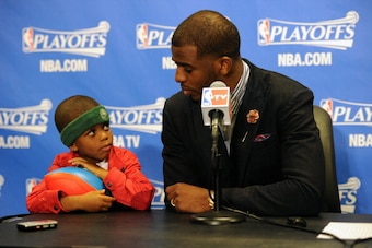 LOS ANGELES, CA - APRIL 21:  Chris Paul #3 of the Los Angeles Clippers and his son Chris Paul II attend a post game press conference after Game Two of the Western Conference Quarterfinals at Staples Center on April 21, 2014 in Los Angeles, California. NOT