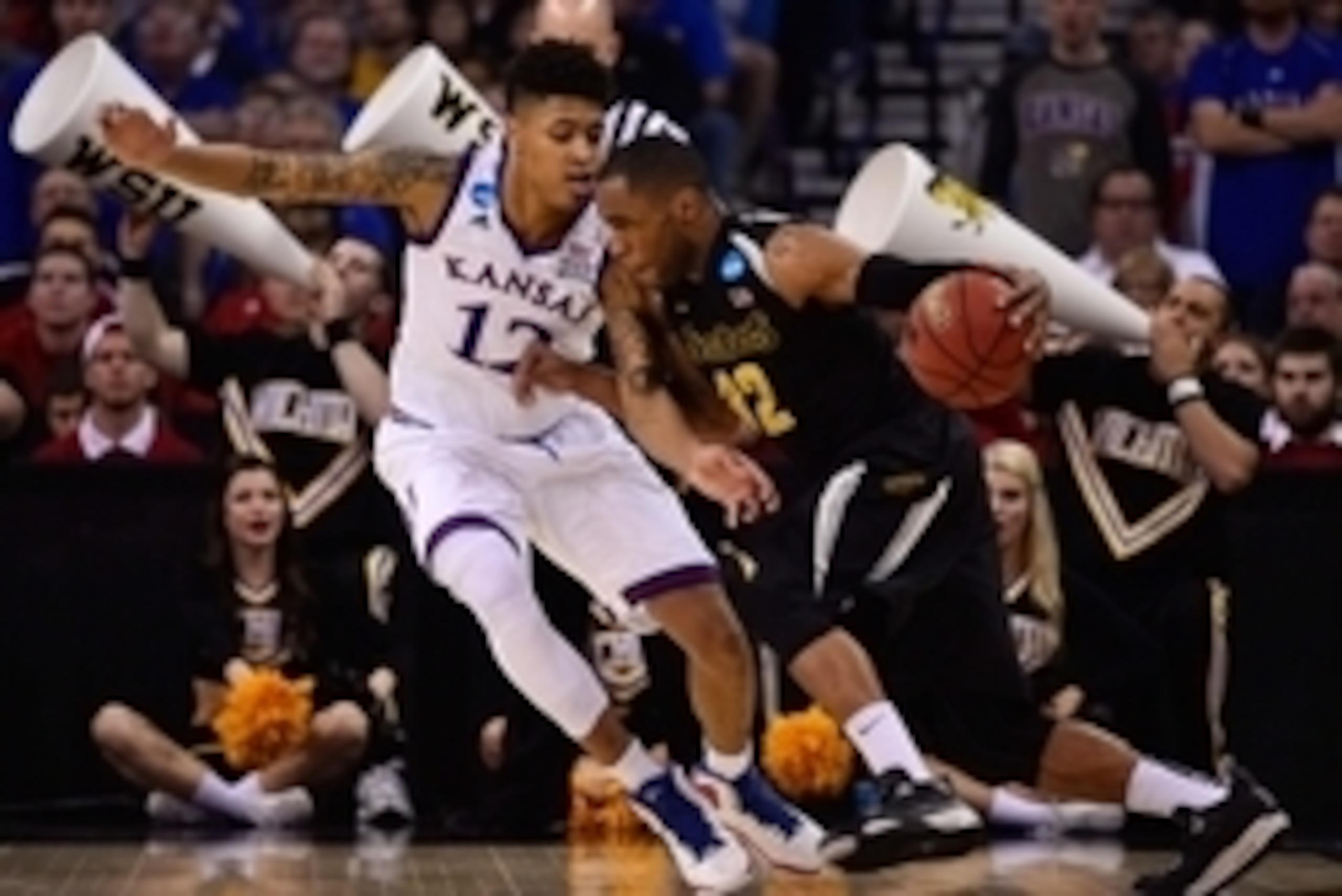 Mar 22, 2015; Omaha, NE, USA; Wichita State Shockers guard Tekele Cotton (32) drives around Kansas Jayhawks guard Kelly Oubre Jr. (12) during the second half in the third round of the 2015 NCAA Tournament at CenturyLink Center. Mandatory Credit: Jasen Vin