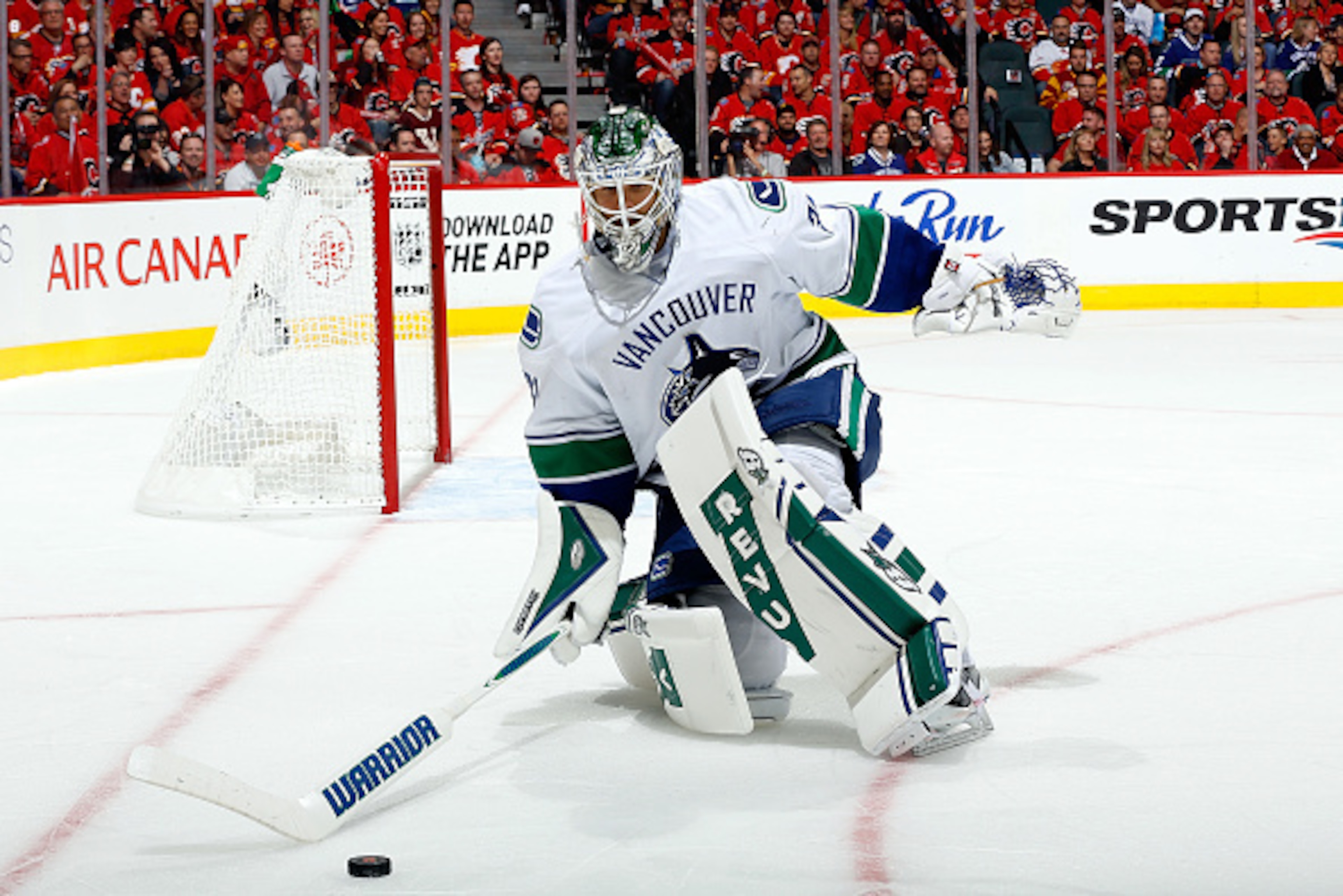 CALGARY, AB - APRIL 19: Eddie Lack #31 the Vancouver Canucks skates out of the crease to handle the puck against the Calgary Flames at Scotiabank Saddledome for Game Three of the Western Quarterfinals during the 2015 NHL Stanley Cup Playoffs on April 19, 