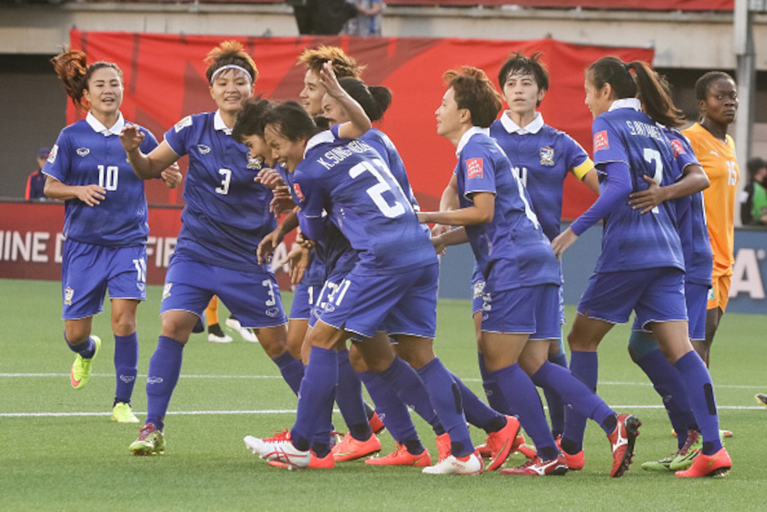 OTTAWA, ON - JUNE 11: Team mates celebrate the second goal by Orathai Srimanee #13 of Thailand during the FIFA Women's World Cup Canada 2015 Group B match between Cote d'Ivoire and Thailand at Lansdowne Stadium on June 11, 2015 in Ottawa, Canada.  (Photo 