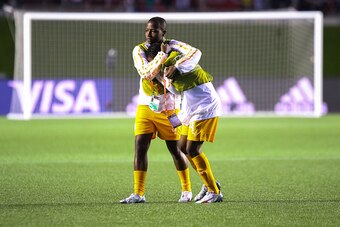 OTTAWA, ON - JUNE 11: Sandrine Niamien #9 of Cote d'Ivoire consoles her team mate Nina Kpaho #4 after their loss in the FIFA Women's World Cup Canada 2015 Group B match between Cote d'Ivoire and Thailand at Lansdowne Stadium on June 11, 2015 in Ottawa, Ca