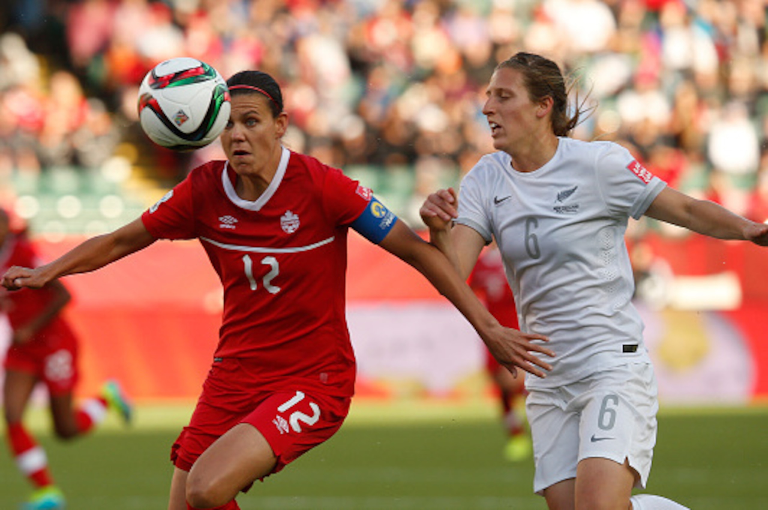 EDMONTON, AB - JUNE 11: Christine Sinclair #12 of Canada keeps the ball from Rebekah Stott #6 of New Zealand during the FIFA Women's World Cup Canada Group A match between Canada and New Zealand at Commonwealth Stadium on June 11, 2015 in Edmonton, Albert