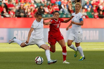 EDMONTON, AB - JUNE 11: Jonelle Filigno #16 of Canada and Ria Percival #2 of New Zealand battle for the ball during the FIFA Women's World Cup Canada Group A match between Canada and New Zealand at Commonwealth Stadium on June 11, 2015 in Edmonton, Albert