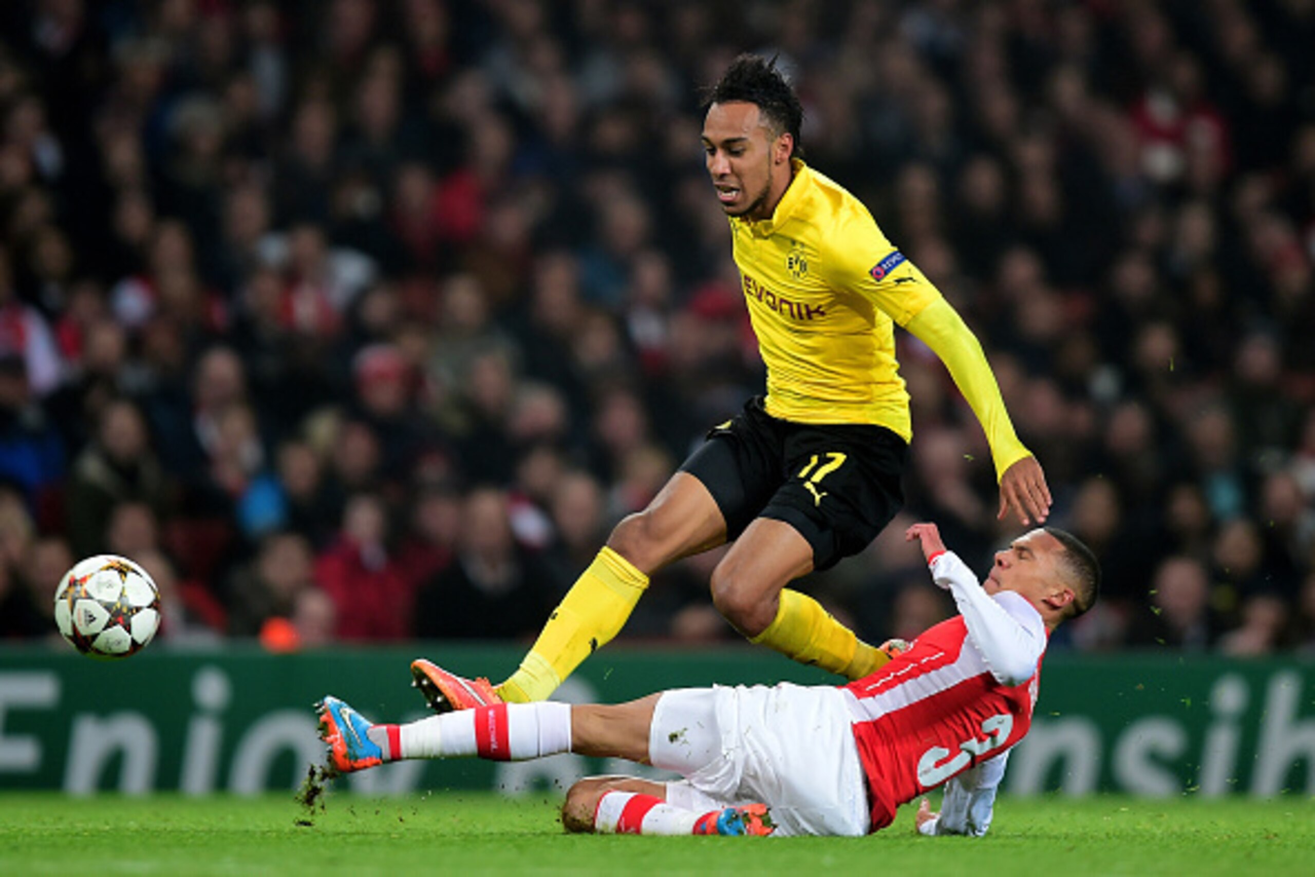 LONDON, ENGLAND - NOVEMBER 26:  Pierre-Emerick Aubameyang of Borussia Dortmund is tackled by Kieran Gibbs of Arsenal during the UEFA Champions League Group D match between Arsenal and Borussia Dortmund at the Emirates Stadium on November 26, 2014 in Londo