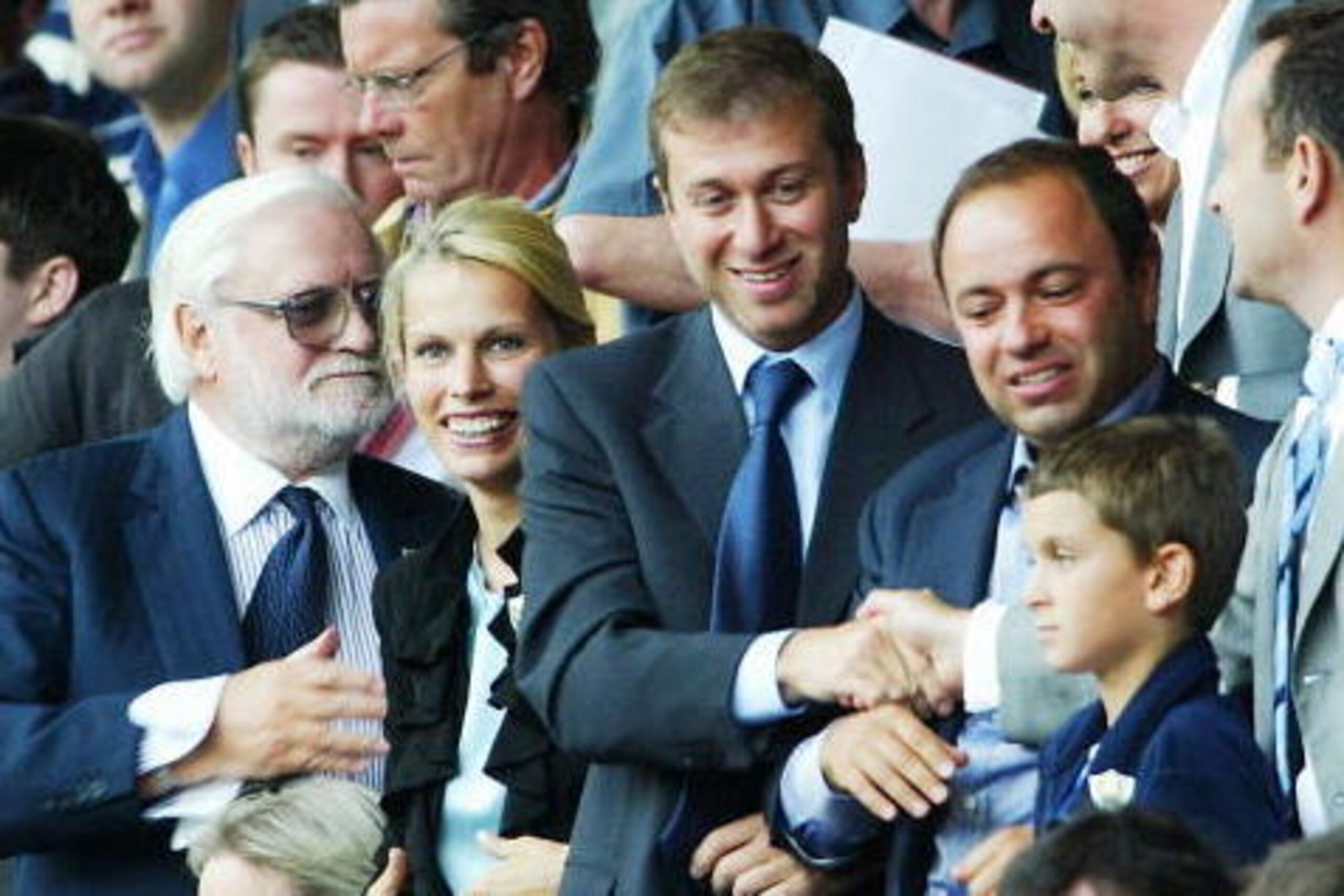 LIVERPOOL, ENGLAND - AUGUST 17:  New Chelsea owner Roman Abramovich (C) is congratulated on his sides win as former Chairman Ken Bates (L) looks on after the FA Barclaycard Premiership match between Liverpool and Chelsea at Anfield on August 17, 2003 in L