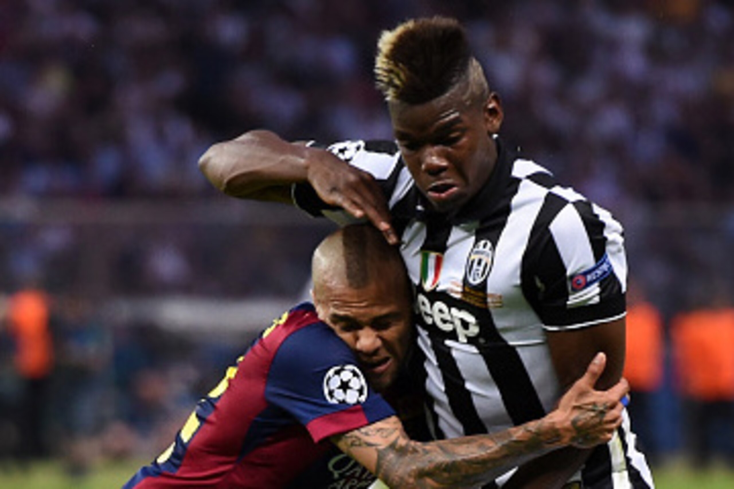 BERLIN, GERMANY - JUNE 06:  Daniel Alves of Barcelona challenges for the ball with Paul Pogba of Juventus during the UEFA Champions League Final between Juventus and FC Barcelona at Olympiastadion on June 6, 2015 in Berlin, Germany.  (Photo by Matthias Ha