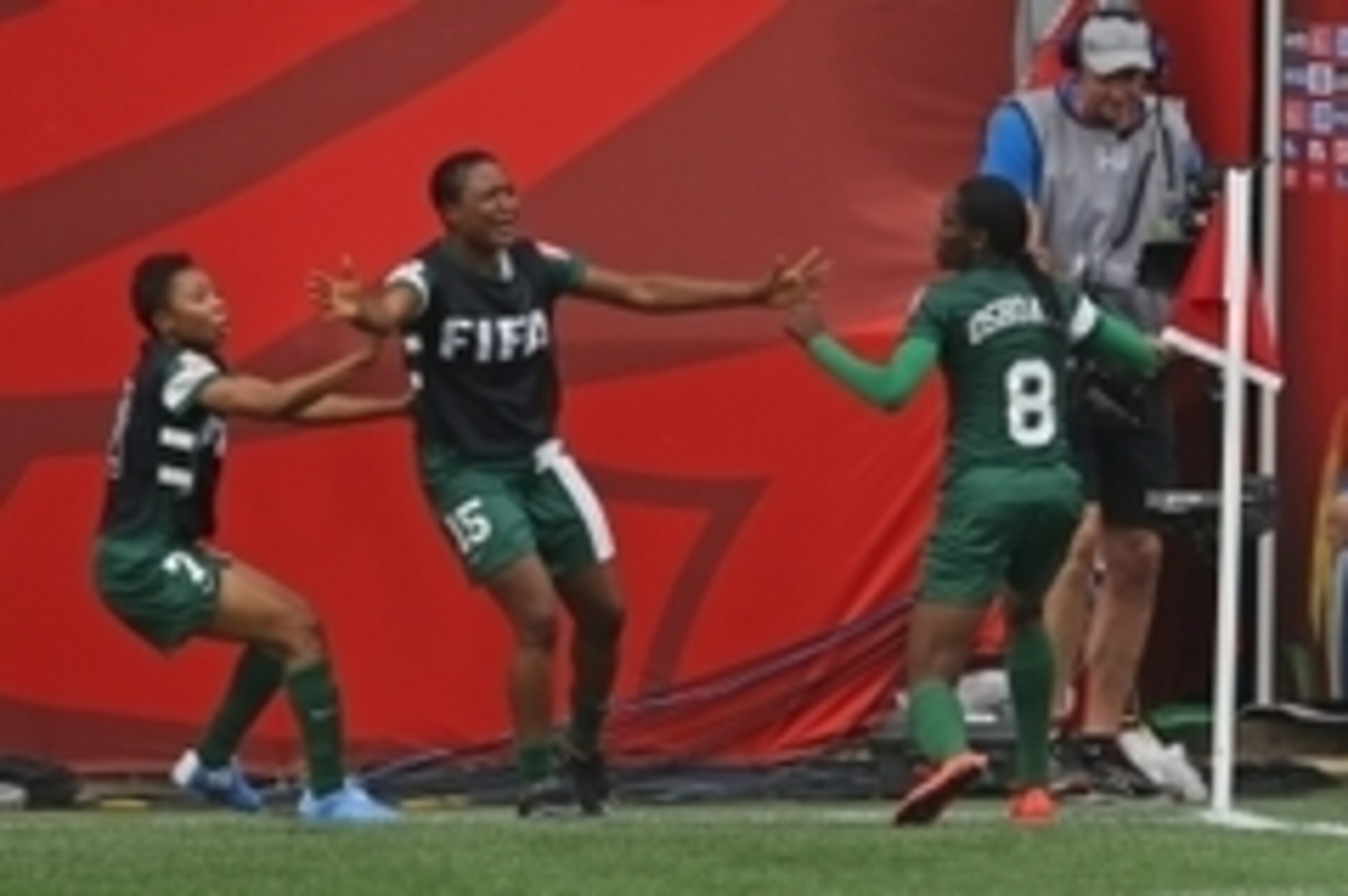 Jun 8, 2015; Winnipeg, Manitoba, CAN; Nigeria forward  Asisat Oshoala (8) celebrates scoring against Sweden with defender Ugo Njoku (15) and forward Esther Sunday (7) in a Group D soccer match in the 2015 women's World Cup at Winnipeg Stadium. Mandatory C
