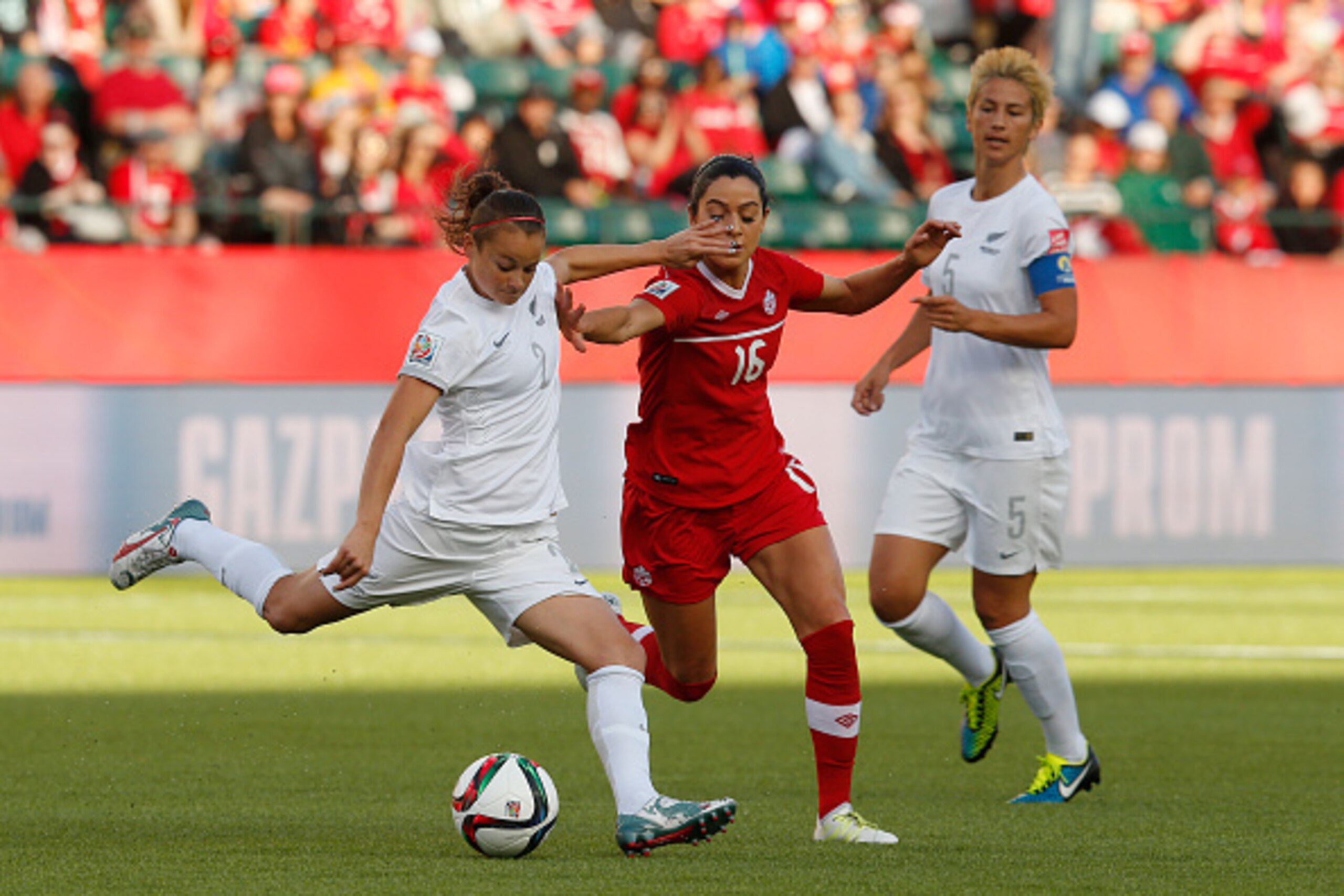 EDMONTON, AB - JUNE 11: Jonelle Filigno #16 of Canada and Ria Percival #2 of New Zealand battle for the ball during the FIFA Women's World Cup Canada Group A match between Canada and New Zealand at Commonwealth Stadium on June 11, 2015 in Edmonton, Albert