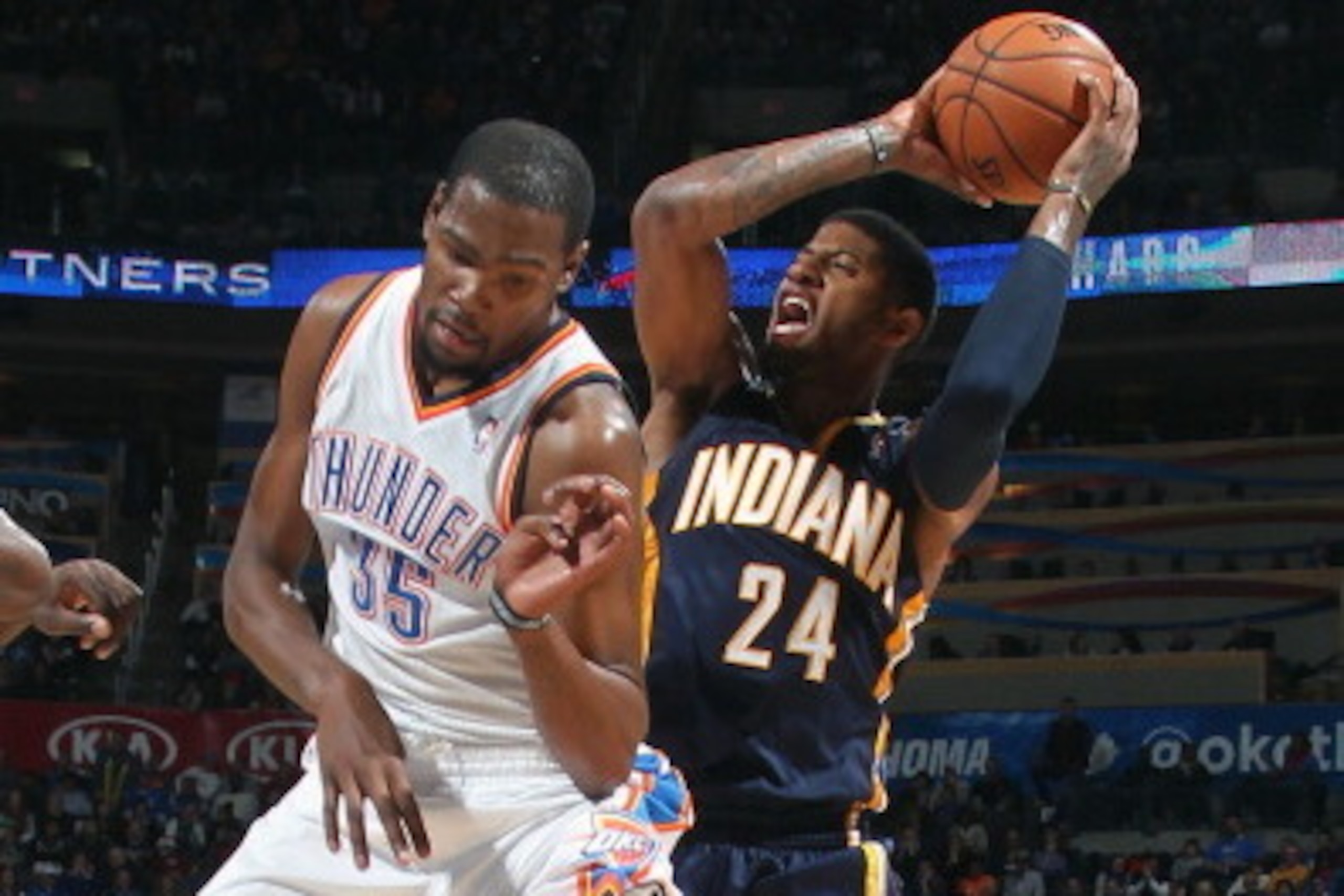 OKLAHOMA CITY, OK - DECEMBER 08:  Paul George #24 of the Indiana Pacers attempts to shoot against Kevin Durant #35 of the Oklahoma City Thunder on December 8, 2013 at the Chesapeake Energy Arena in Oklahoma City, Oklahoma. NOTE TO USER: User expressly ack