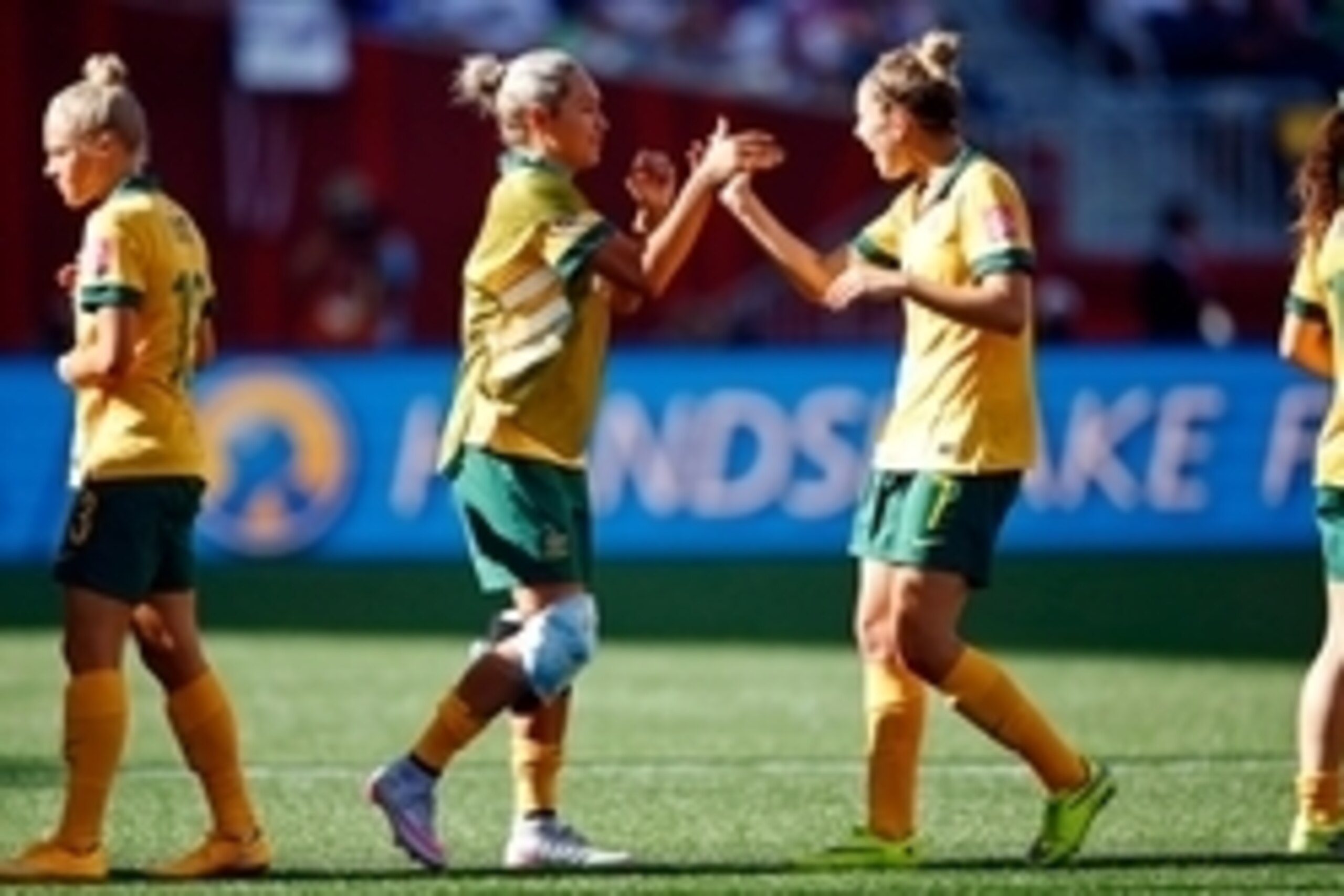 Jun 12, 2015; Winnipeg, Manitoba, CAN; Australia forward Kyah Simon (17) high fives defender Steph Catley (7) after their win over Nigeria in a Group D soccer match in the 2015 FIFA women's World Cup at Winnipeg Stadium. Australia won 2-0.  Mandatory Cred