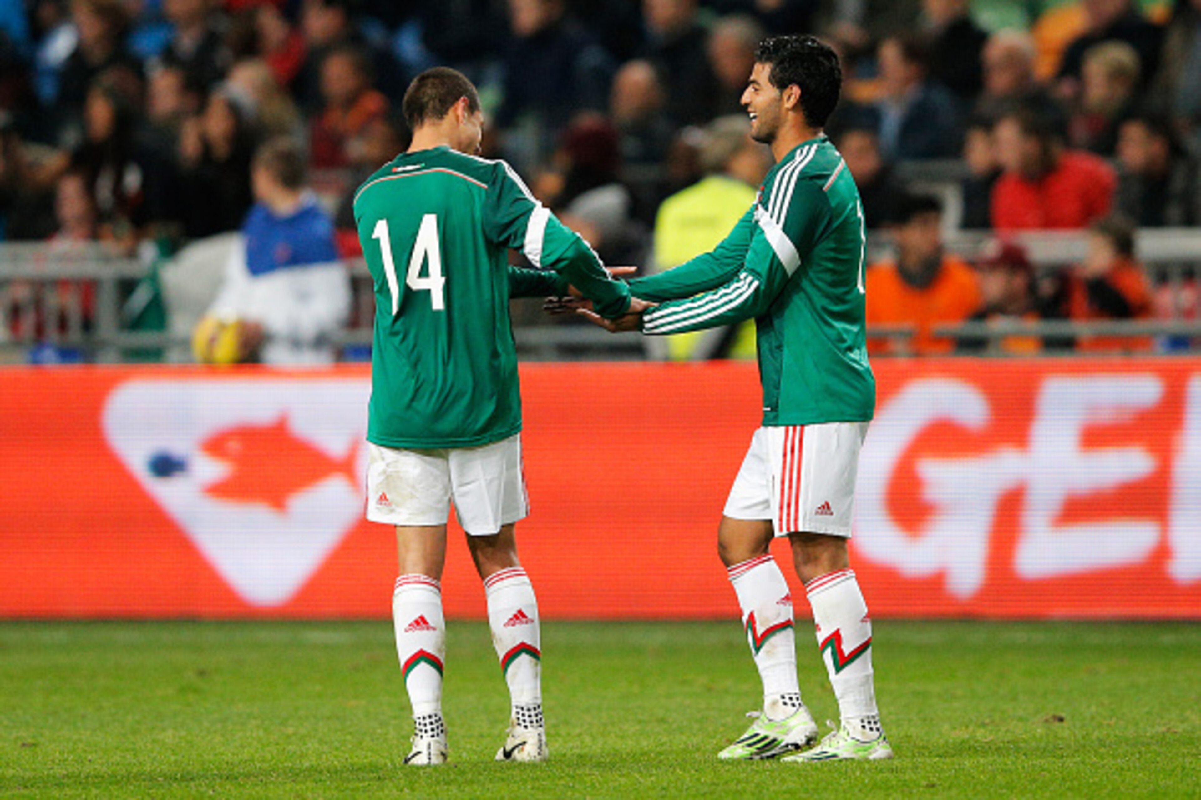 AMSTERDAM, NETHERLANDS - NOVEMBER 12:  Carlos Vela #11 of Mexico is congratulated by team mate Javier Hernandez after scoring the second goal of the game for his team during the international friendly match between Netherlands and Mexico held at the Amste