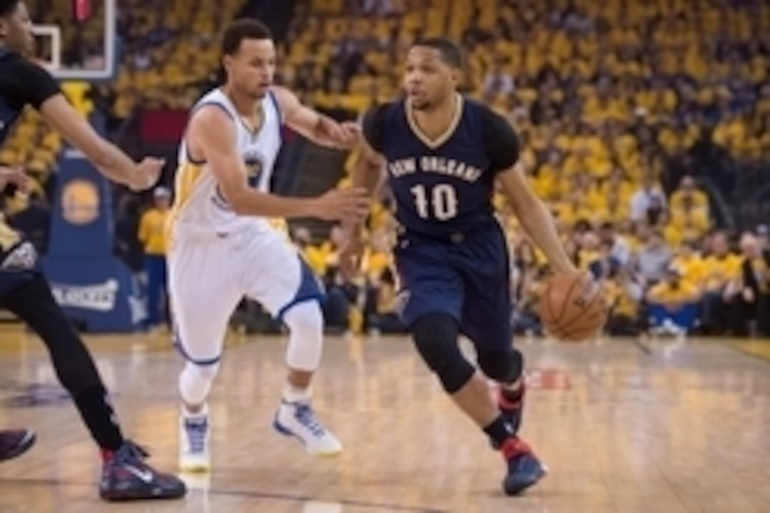 April 20, 2015; Oakland, CA, USA; New Orleans Pelicans guard Eric Gordon (10) dribbles the basketball against Golden State Warriors guard Stephen Curry (30) during the first quarter in game two of the first round of the NBA Playoffs at Oracle Arena. The W