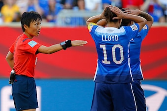 WINNIPEG, MB - JUNE 12:  Head referee Sachiko Yamagishi makes a call in the first half as Carli Lloyd #10 and Sydney Leroux #2 of the United States of the United States react as they take on Sweden in the FIFA Women's World Cup Canada 2015 match between t