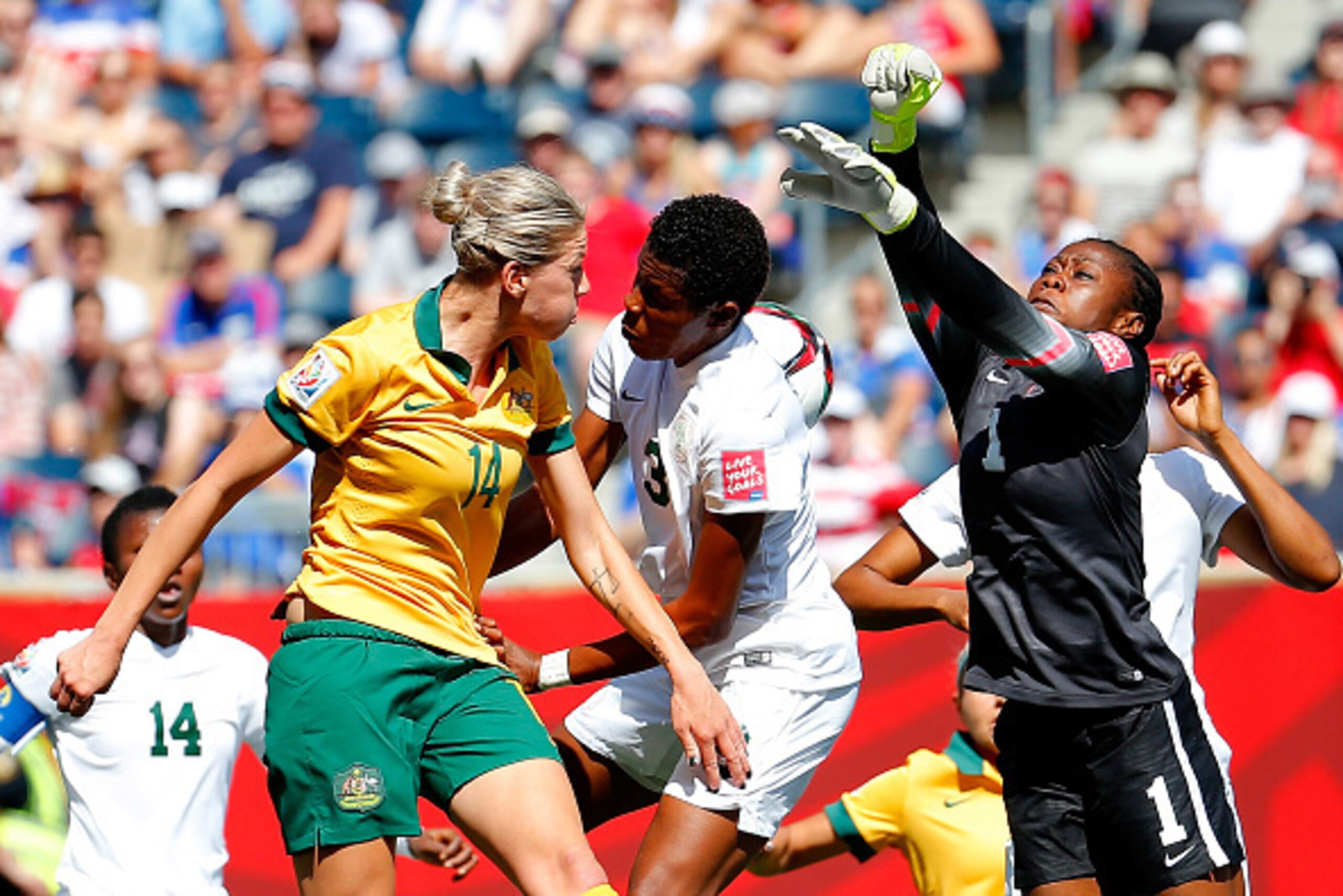 WINNIPEG, MB - JUNE 12:  Goalkeeper Precious Dede #1 and Osinachi Ohale #3 of Nigeria defend a corner kick against Alanna Kennedy #14 of Australia during the FIFA Women's World Cup Canada 2015 match between Australia and Nigeria at Winnipeg Stadium on Jun