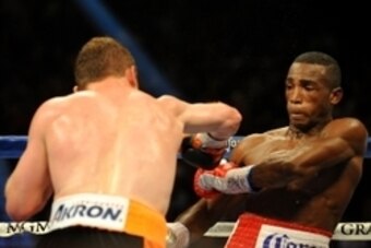 Jul 12, 2014; Las Vegas, NV, USA; Erislandy Lara (red trunks) evades a punch thrown by Canelo Alvarez (gold trunks) during a superwelterweight bout at MGM Grand. Mandatory Credit: Stephen R. Sylvanie-USA TODAY Sports