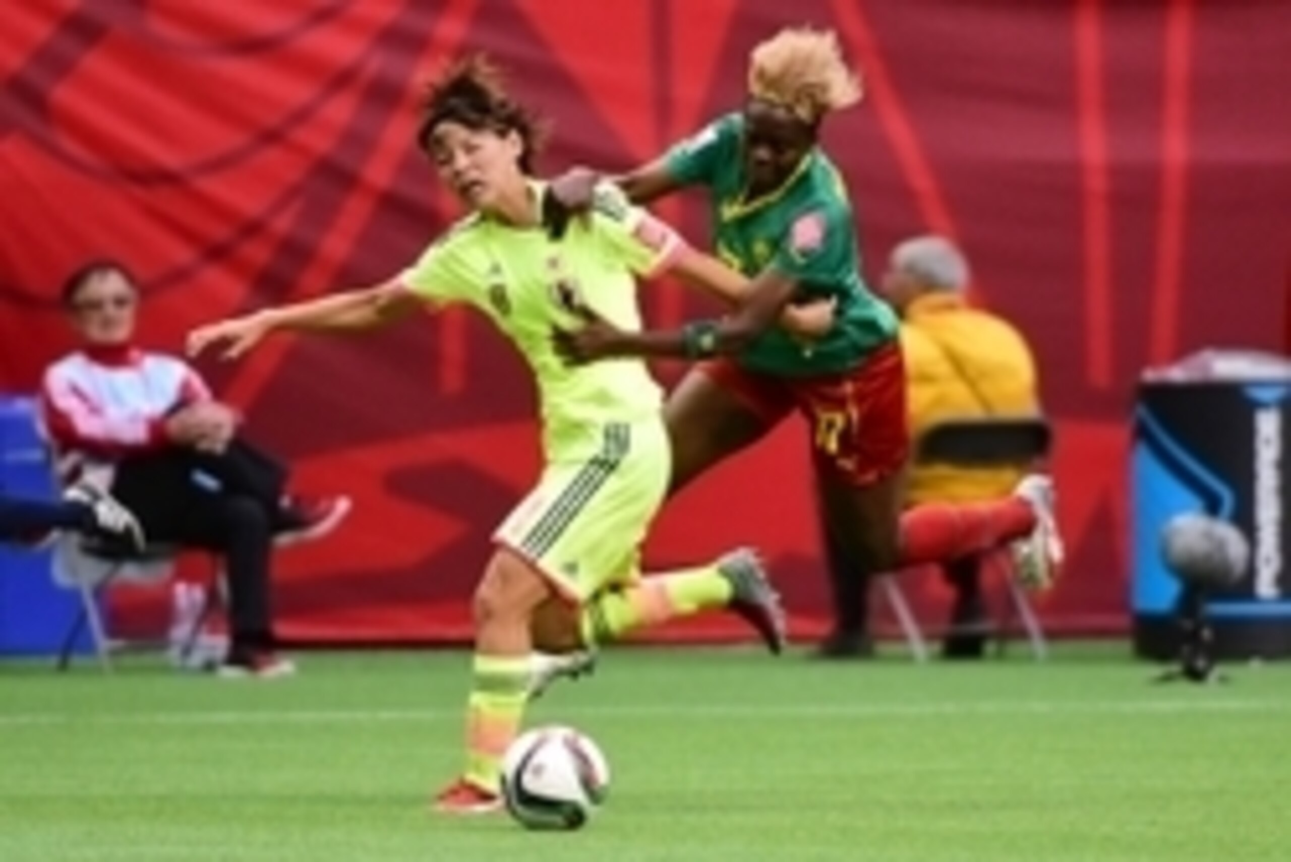 Jun 12, 2015; Vancouver, British Columbia, CAN; Japan defender Saki Kumagai (4) and Cameroon forward Gaelle Enganamouit (17) battle for the ball during the first half in a Group C soccer match in the 2015 FIFA women's World Cup at BC Place Stadium. Engana