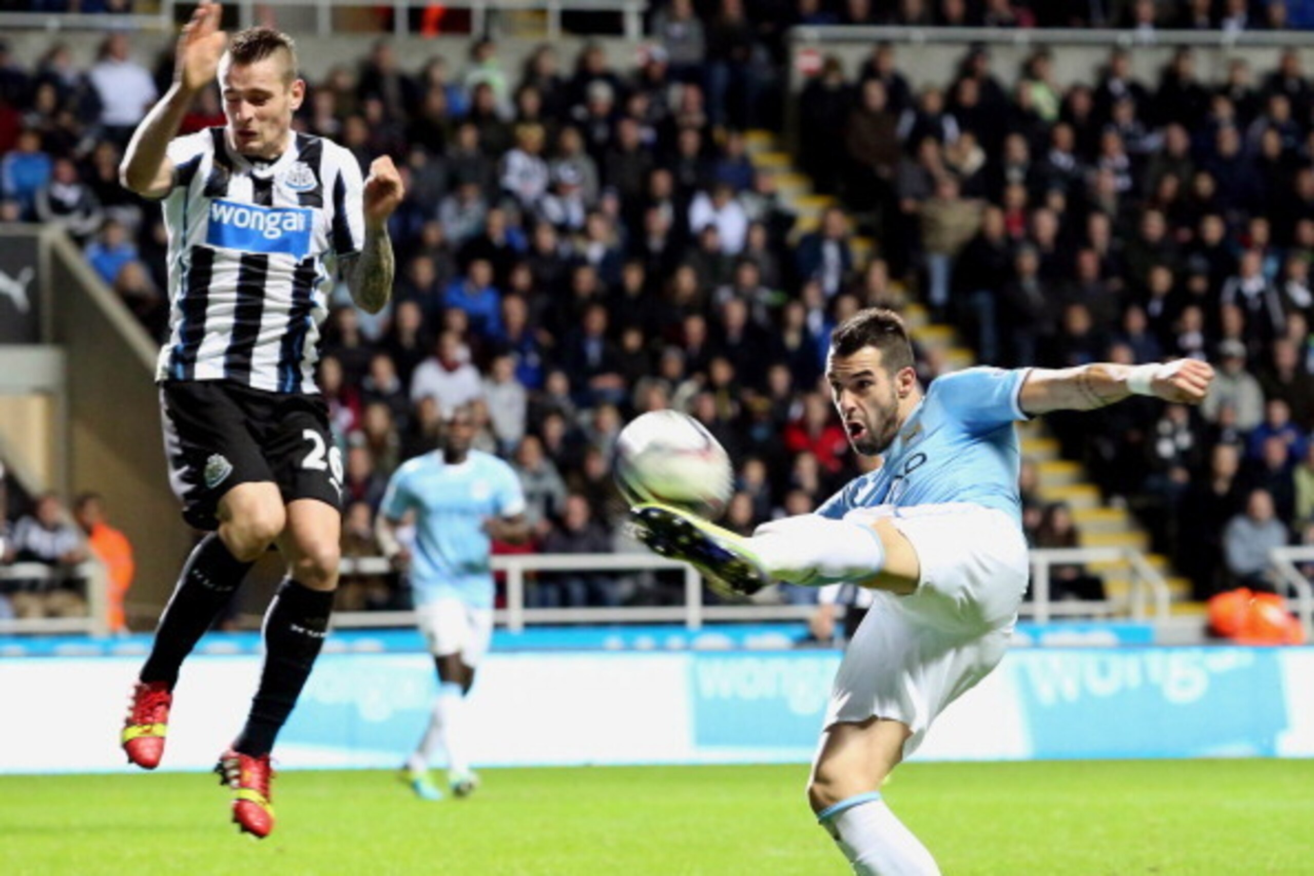 NEWCASTLE, UNITED KINGDOM - OCTOBER 30:  Alvaro Negredo (R) of Manchester City in action with Mathieu Debuchy of Newcastle United during the Capital One Cup Fourth Round match between Newcastle United and Manchester City at St James' Park on October 30, 2