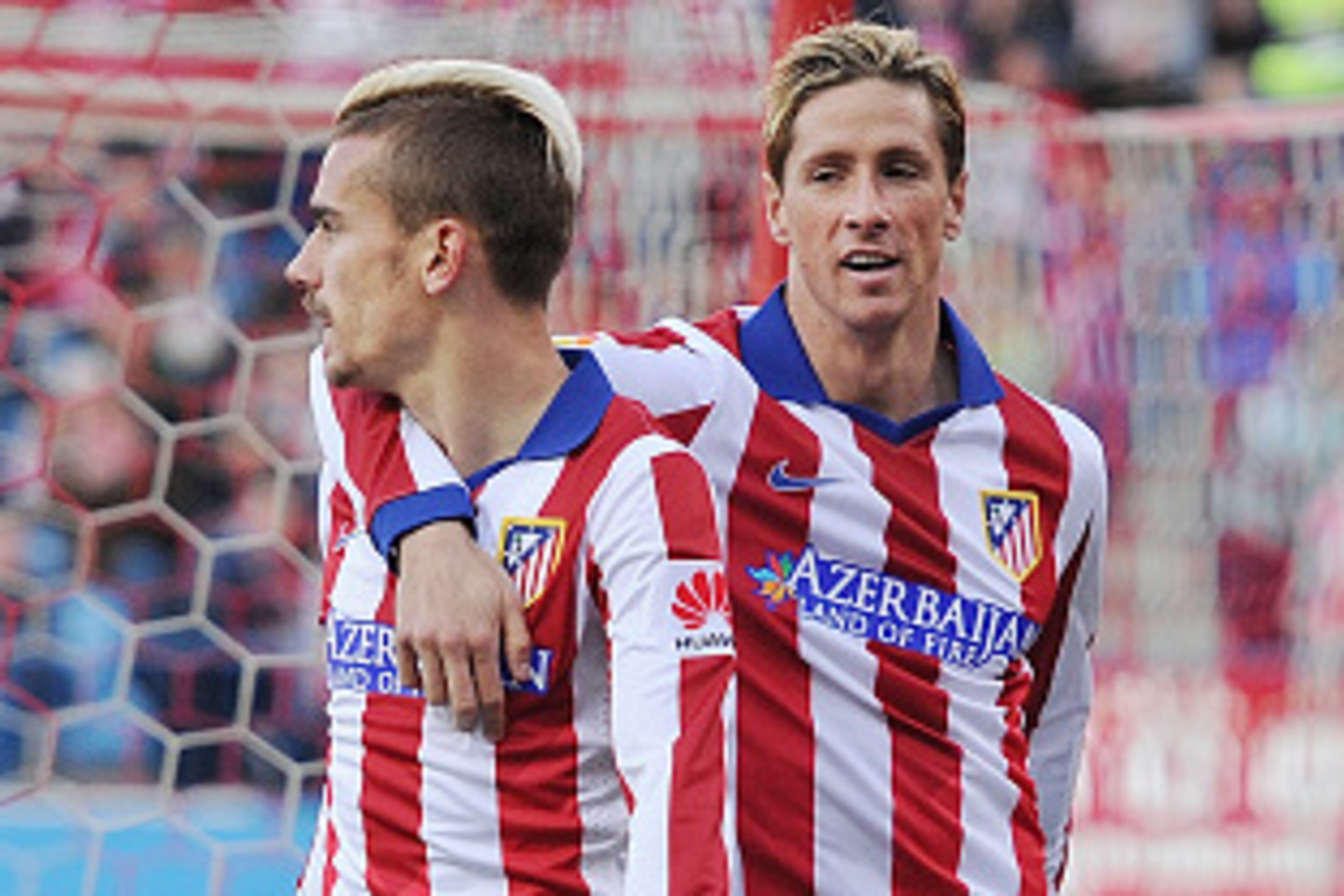 MADRID, SPAIN - APRIL 07:  Antoine Griezmann of Club Atletico de Madrid celebrates with Fernando Torres after scoring his team's 2nd goal during the La Liga match between Club Atletico de Madrid and Real Sociedad at Vicente Calderon Stadium on April 7, 20